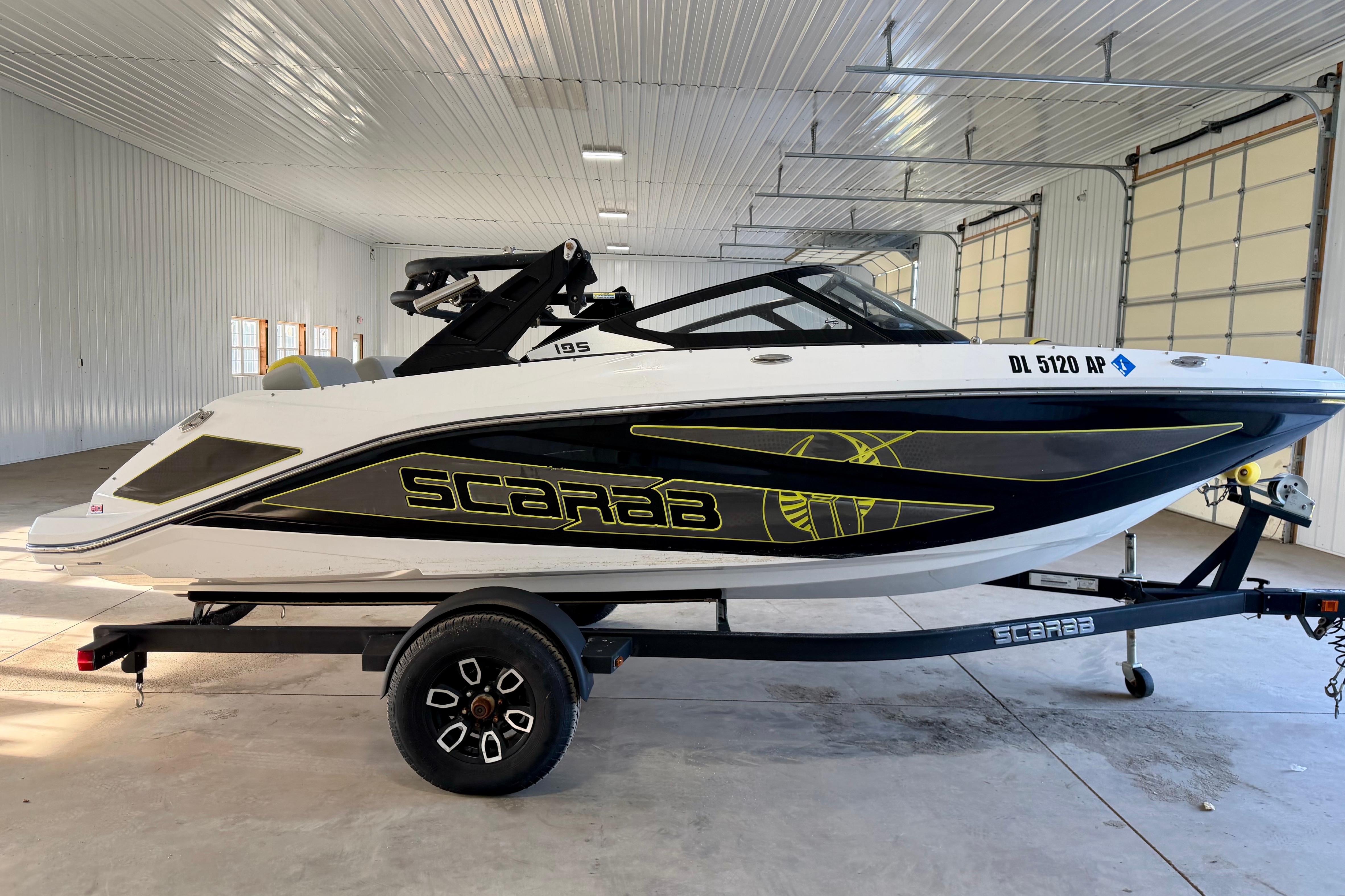 2023 Scarab 195 ID boat on trailer in spacious indoor garage.