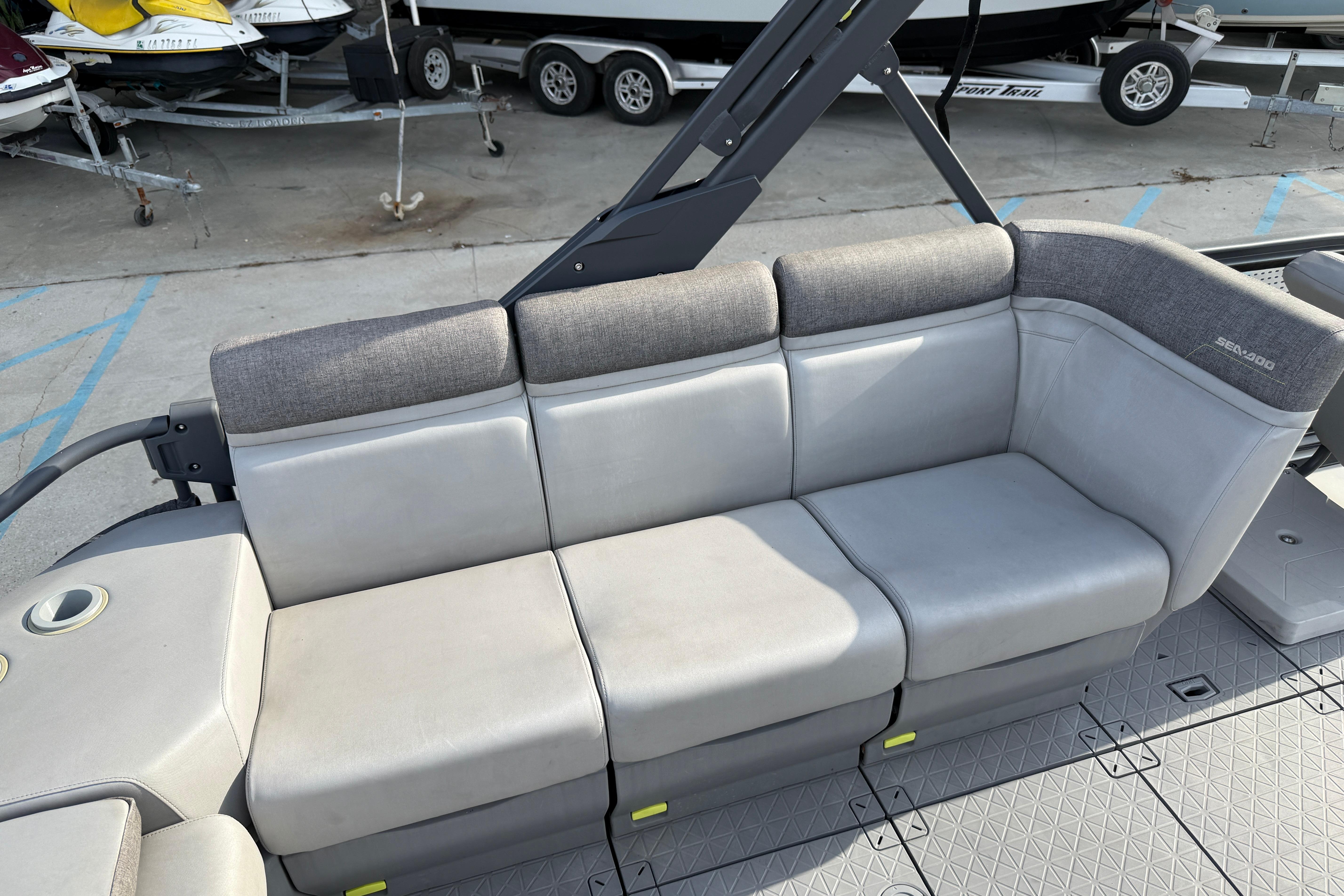 2023 Sea-Doo Switch Sport 18 boat seating area with gray upholstery and cup holder.