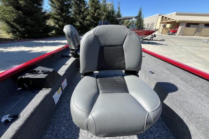2025 Tracker Super Guide V-16 T boat seat, gray and black, outdoor setting.
