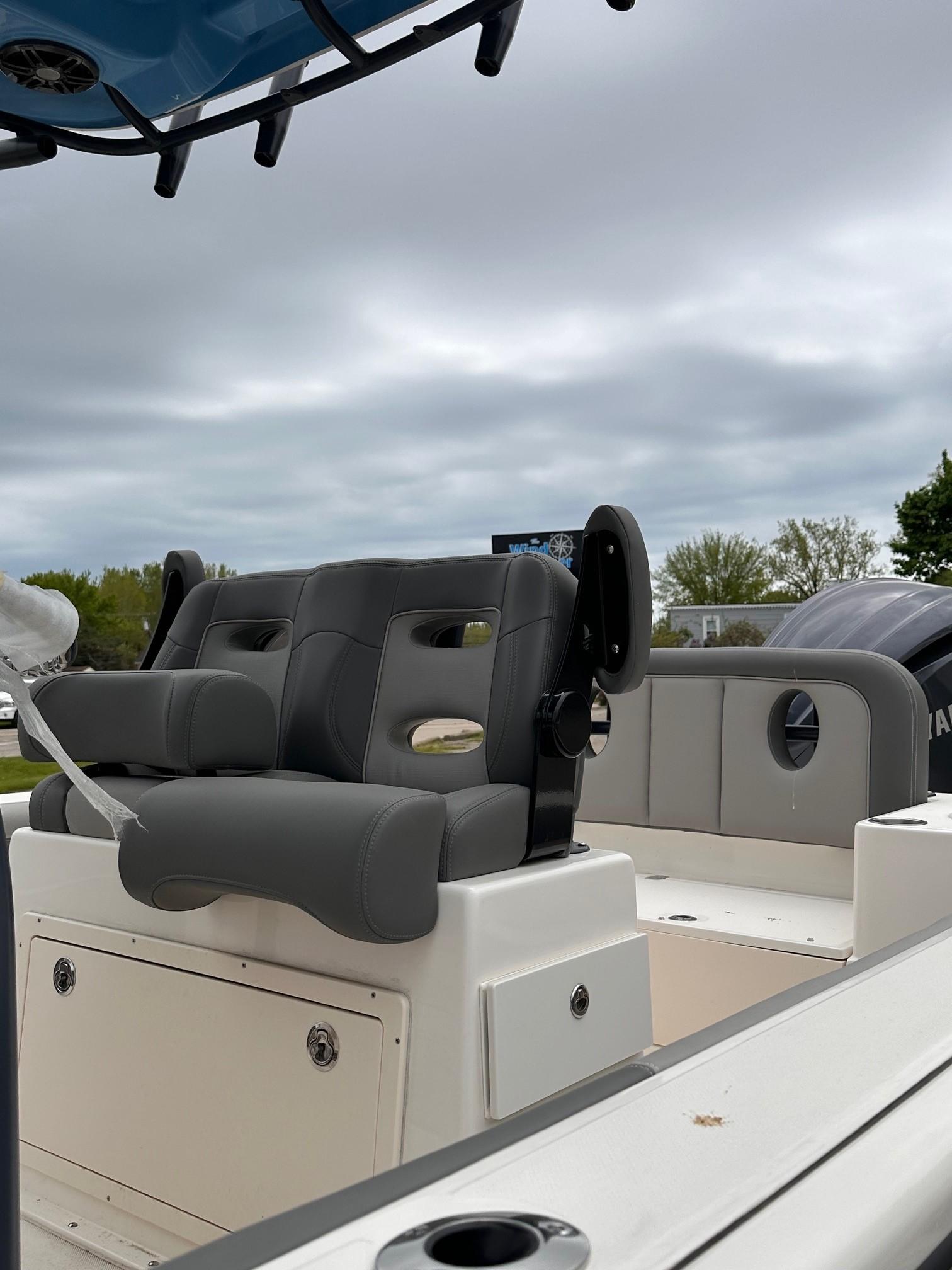 2024 Sea Born LX24 Center Console boat with cushioned seating and storage compartments.
