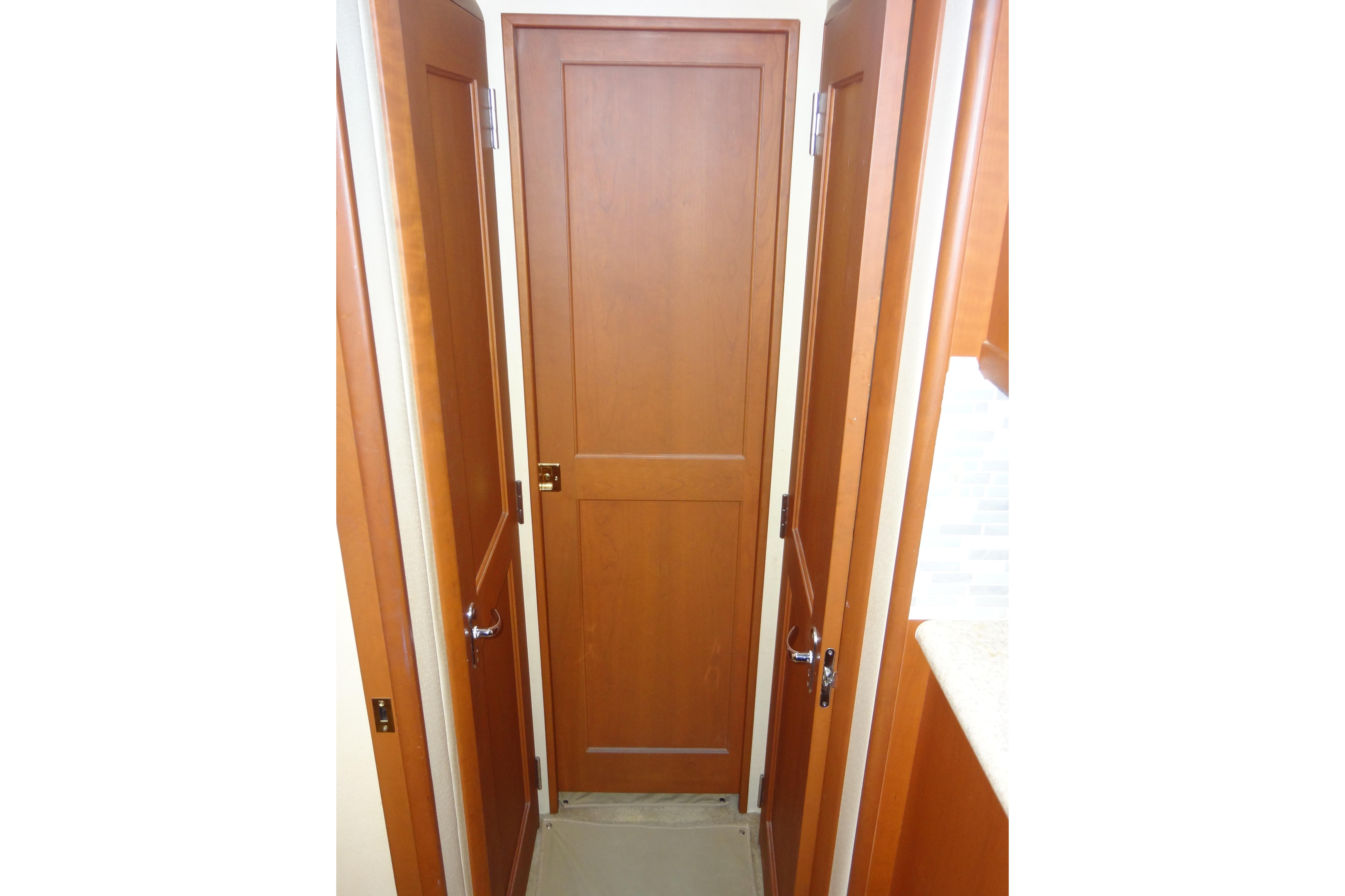 Interior view of 2005 Silverton 34 Convertible boat with wooden doors.