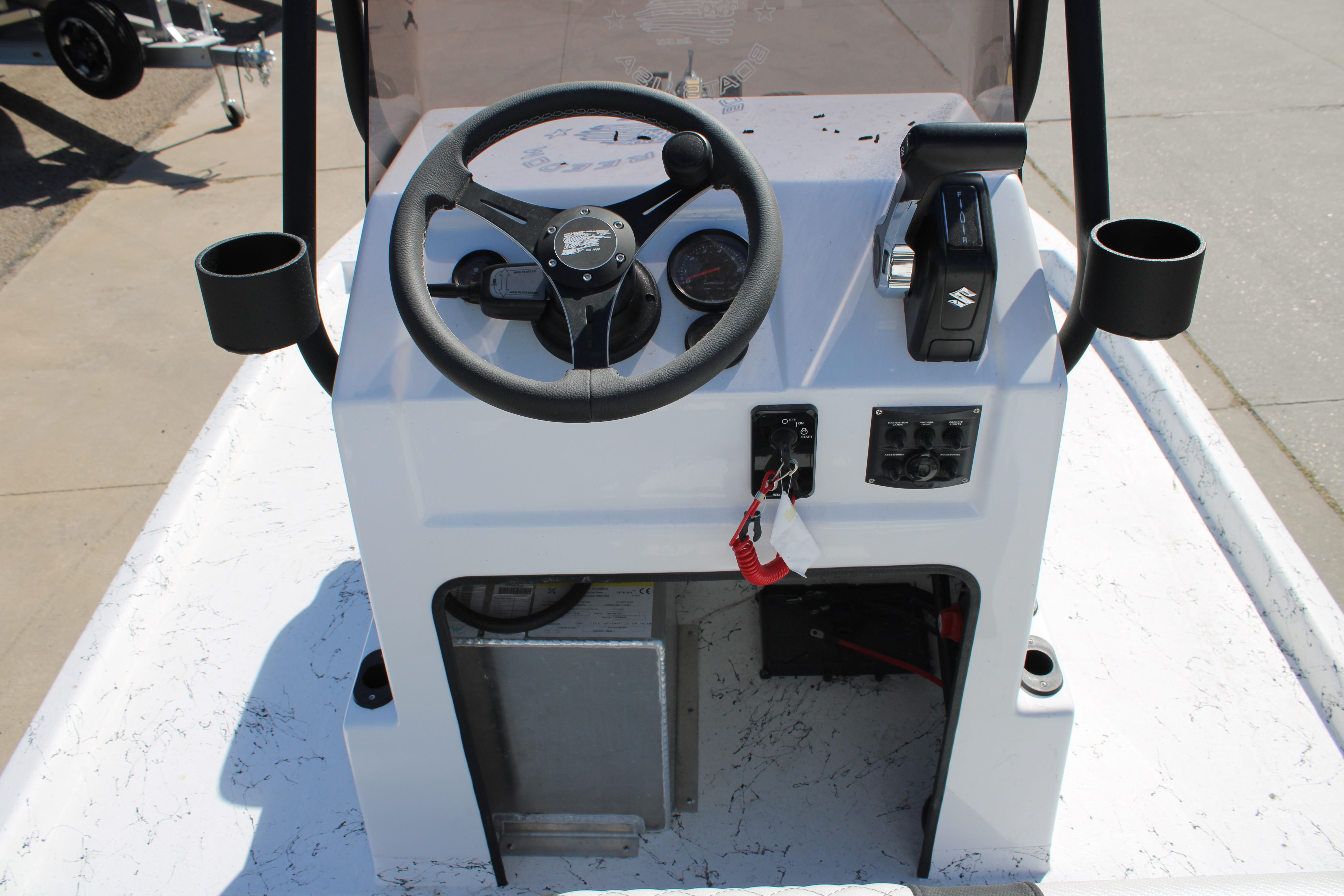 2026 Freedom Boats Chiquita console with steering wheel and controls.