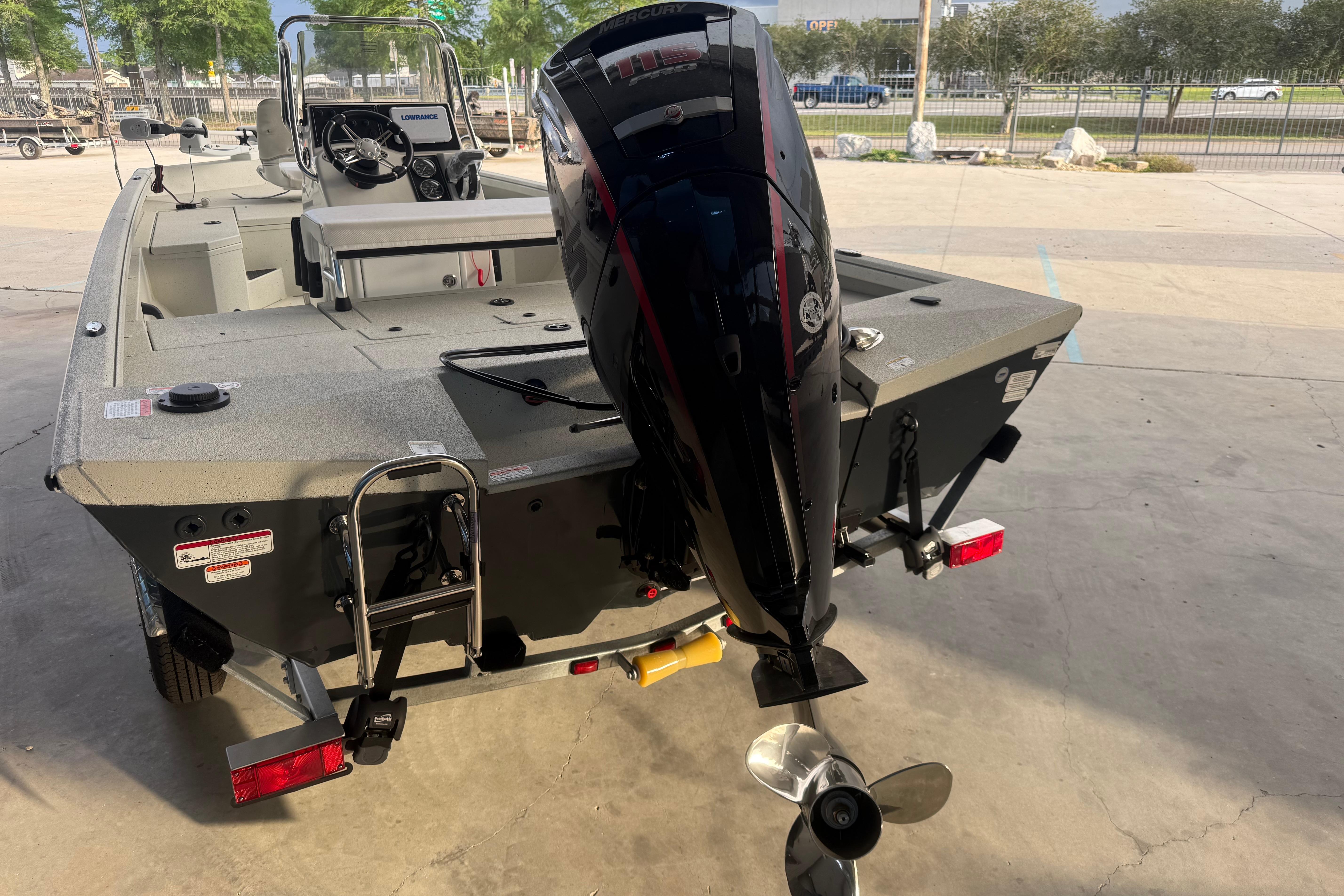 2026 Ranger RB190 boat with outboard motor, parked on a trailer in a sunny outdoor setting.