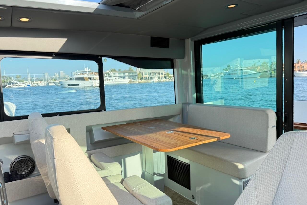 Interior of 2024 Saxdor 320 GTC yacht with waterfront view and seating area.