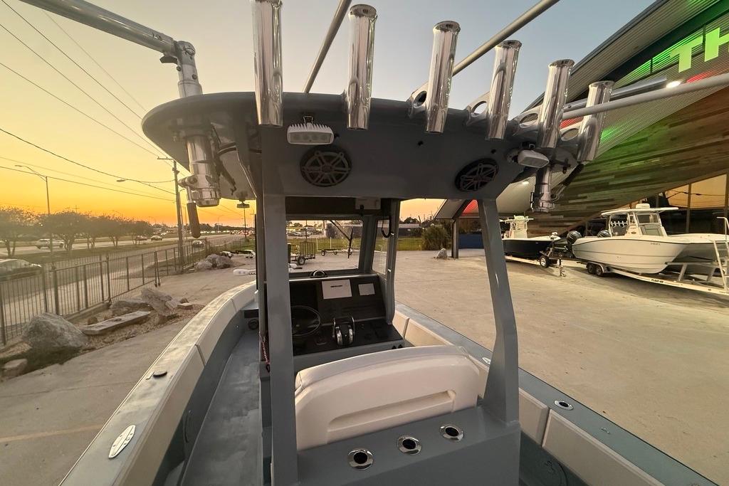 2019 Metal Shark 28 CC boat interior at sunset, showcasing helm and rod holders.