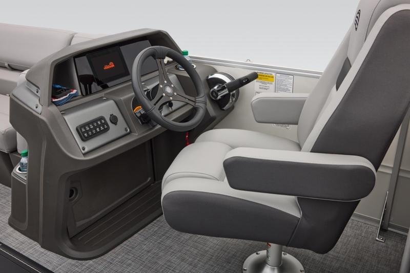 2026 Sun Tracker Party Barge 22 DLX helm with steering wheel and captain's chair.
