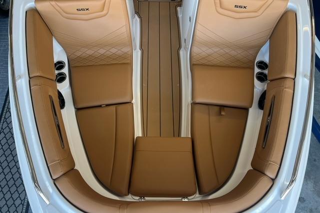 2025 Chaparral 247 SSX boat interior with tan leather seating and cup holders.