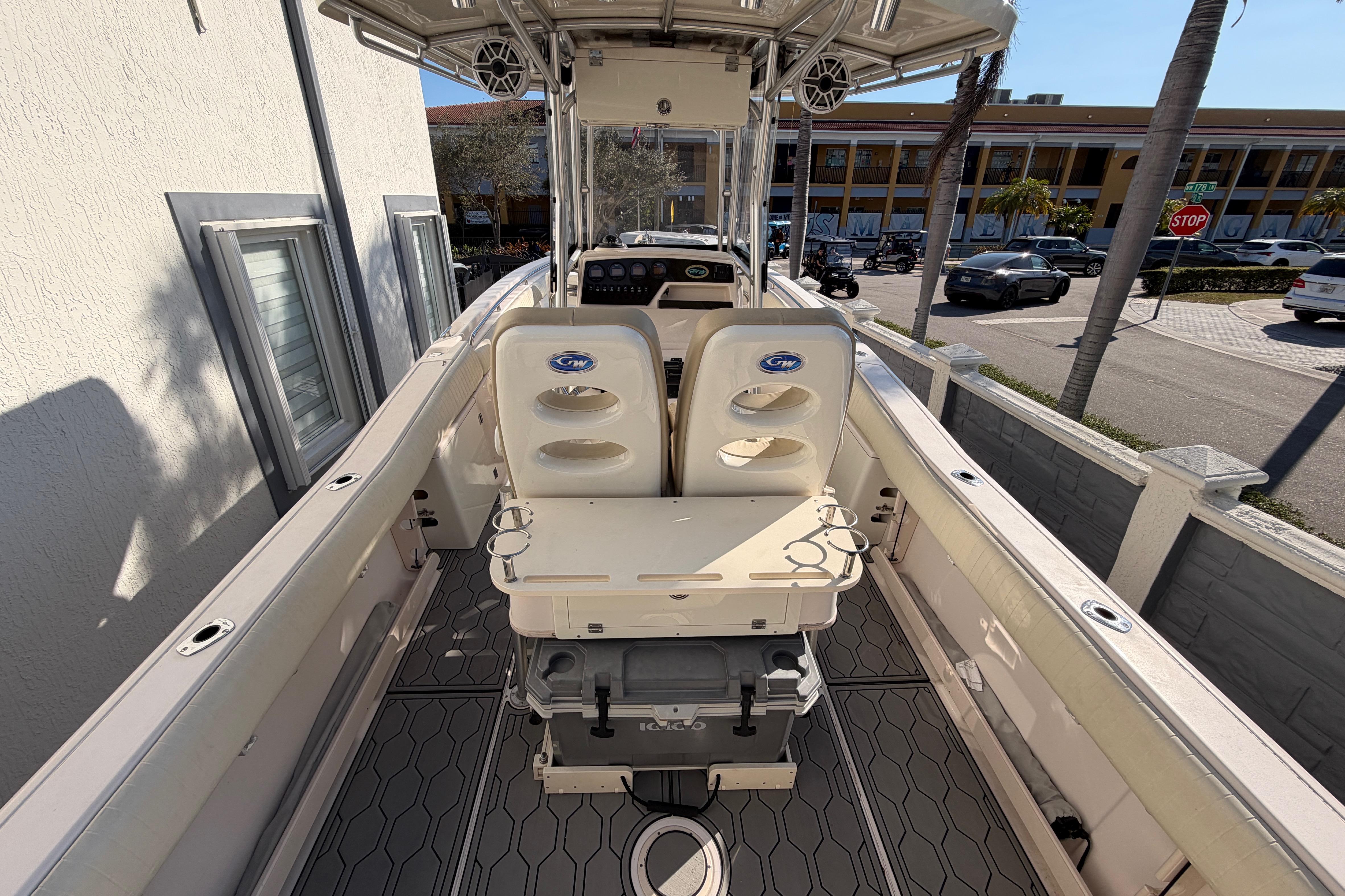 2004 Grady White 273 boat interior with seating and console, docked near a street.