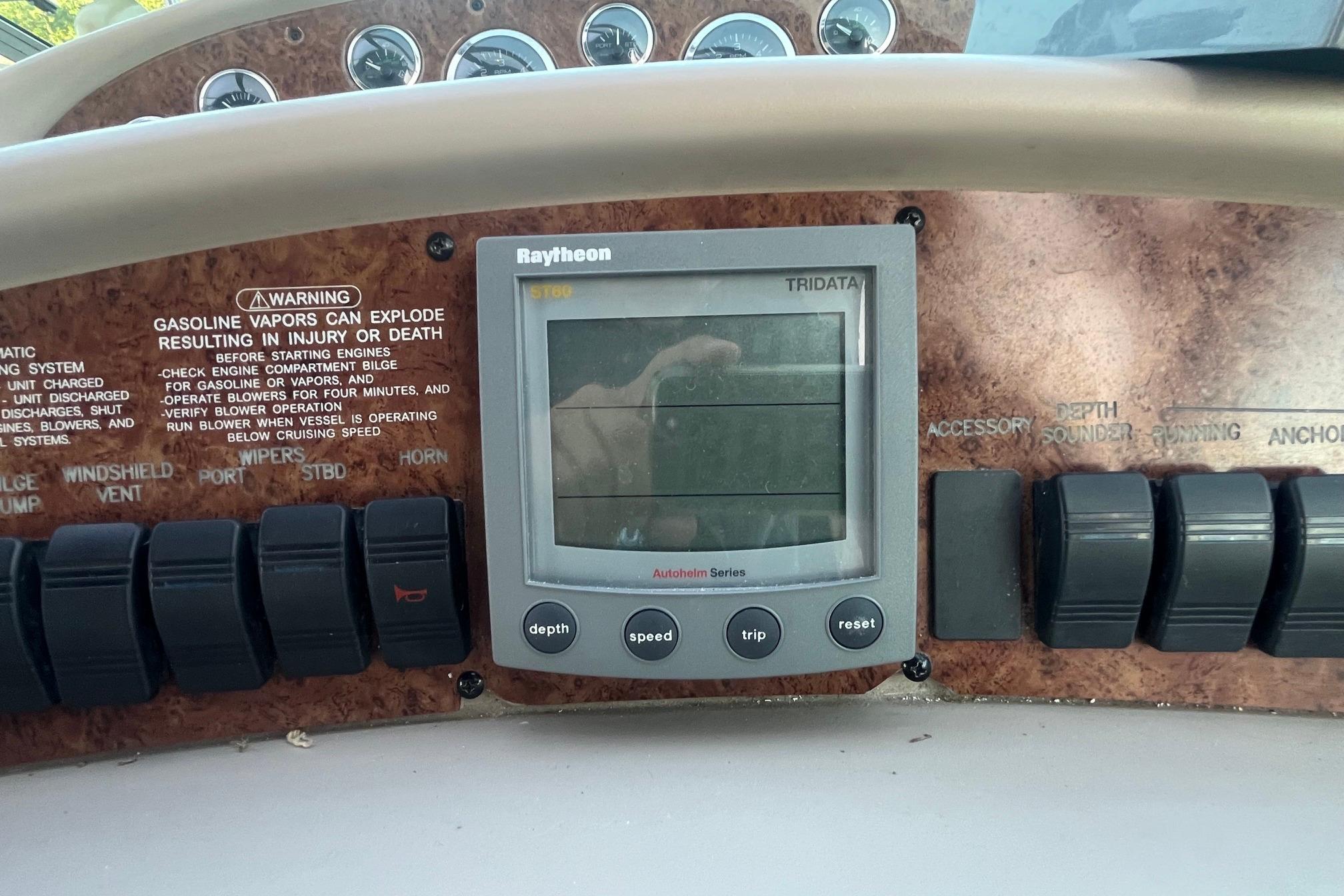 Control panel of a 2001 Sea Ray 340 Sundancer boat with Raytheon display.