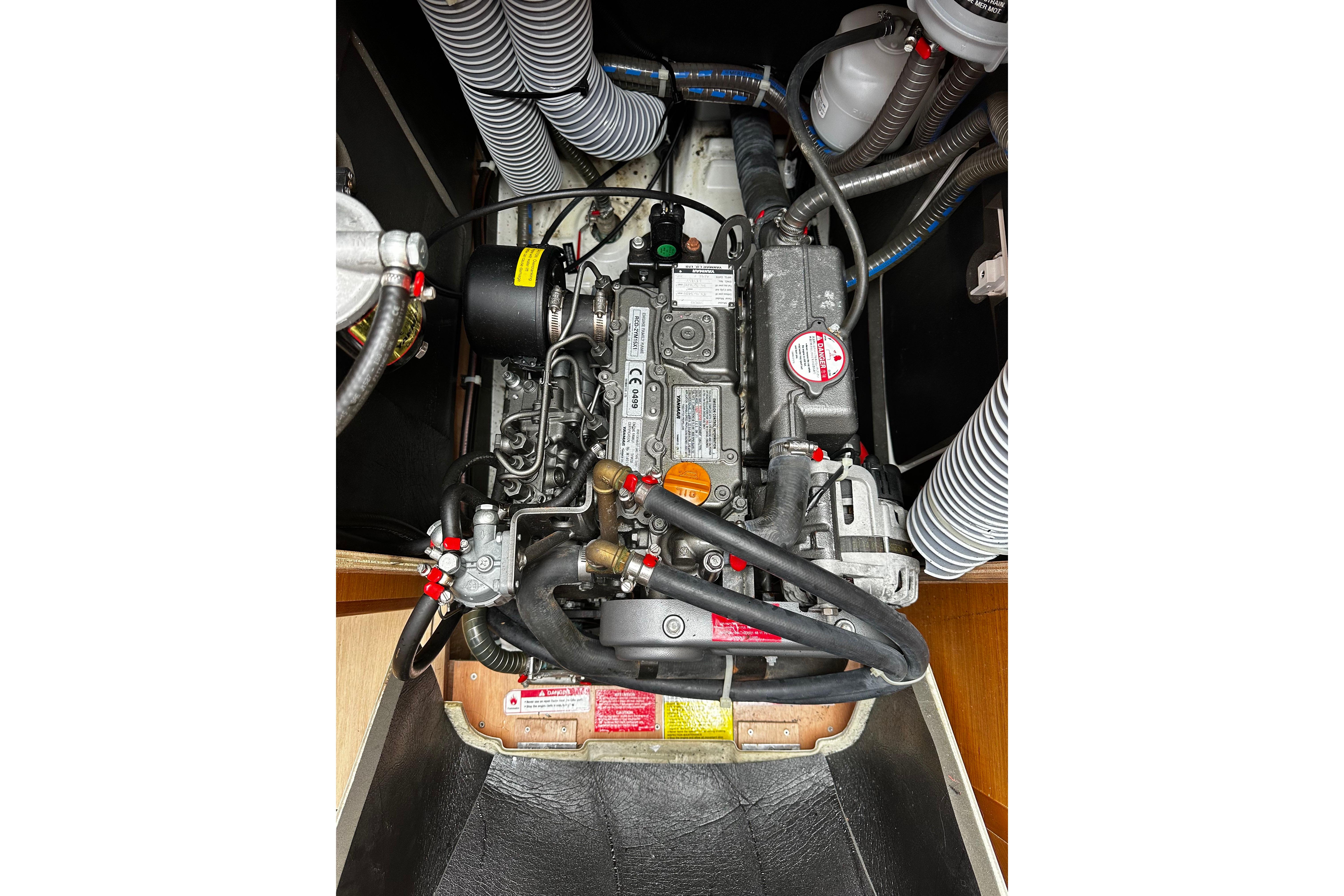 Engine compartment of a 2016 Jeanneau Sun Odyssey 349 sailboat, showcasing mechanical components.