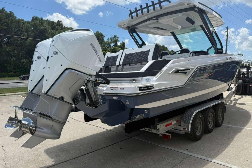 2026 Monterey Elite 30 OB boat with dual Mercury outboard engines on a trailer.