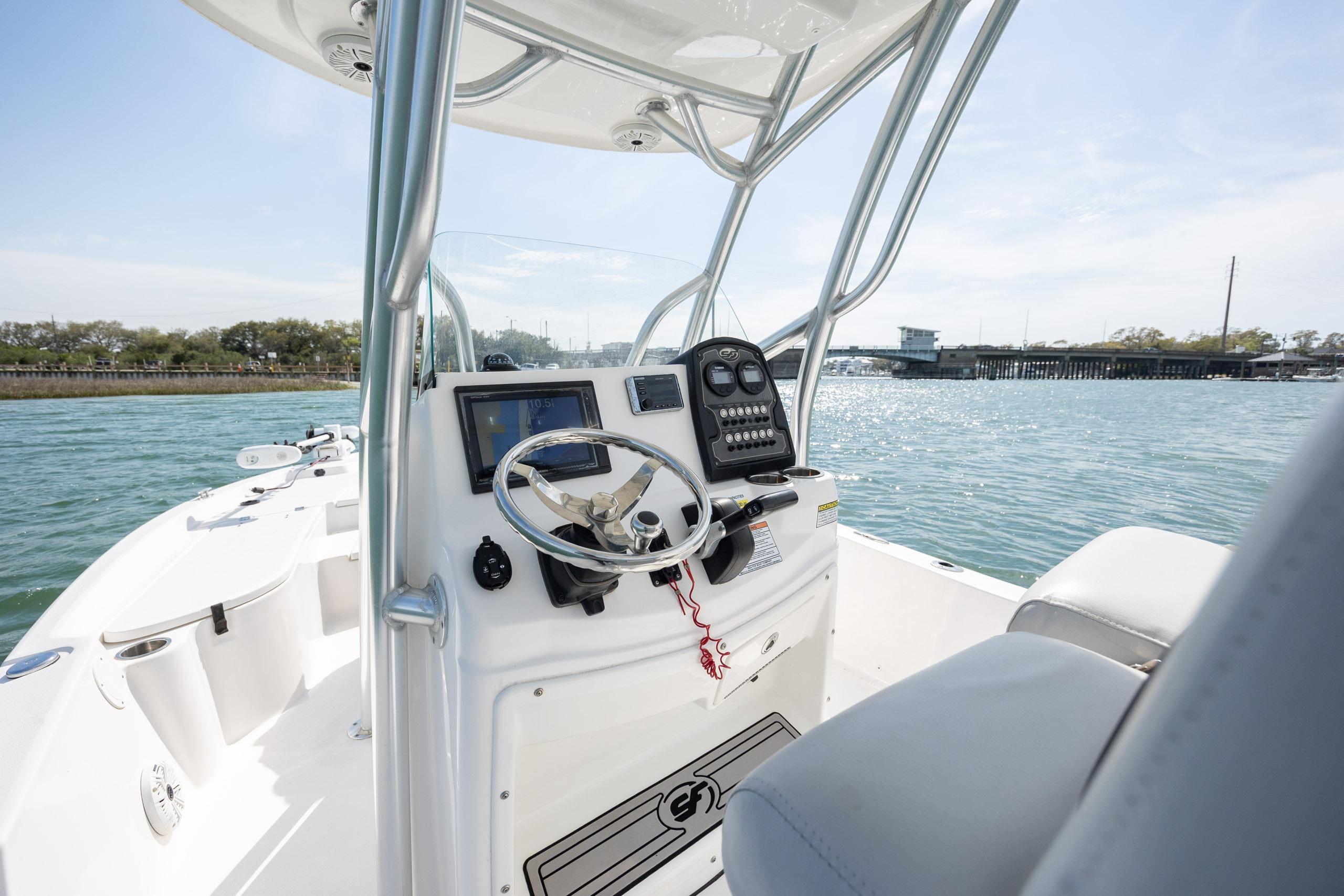 2019 Sea Fox 220 Viper boat console with steering wheel and controls on open water.