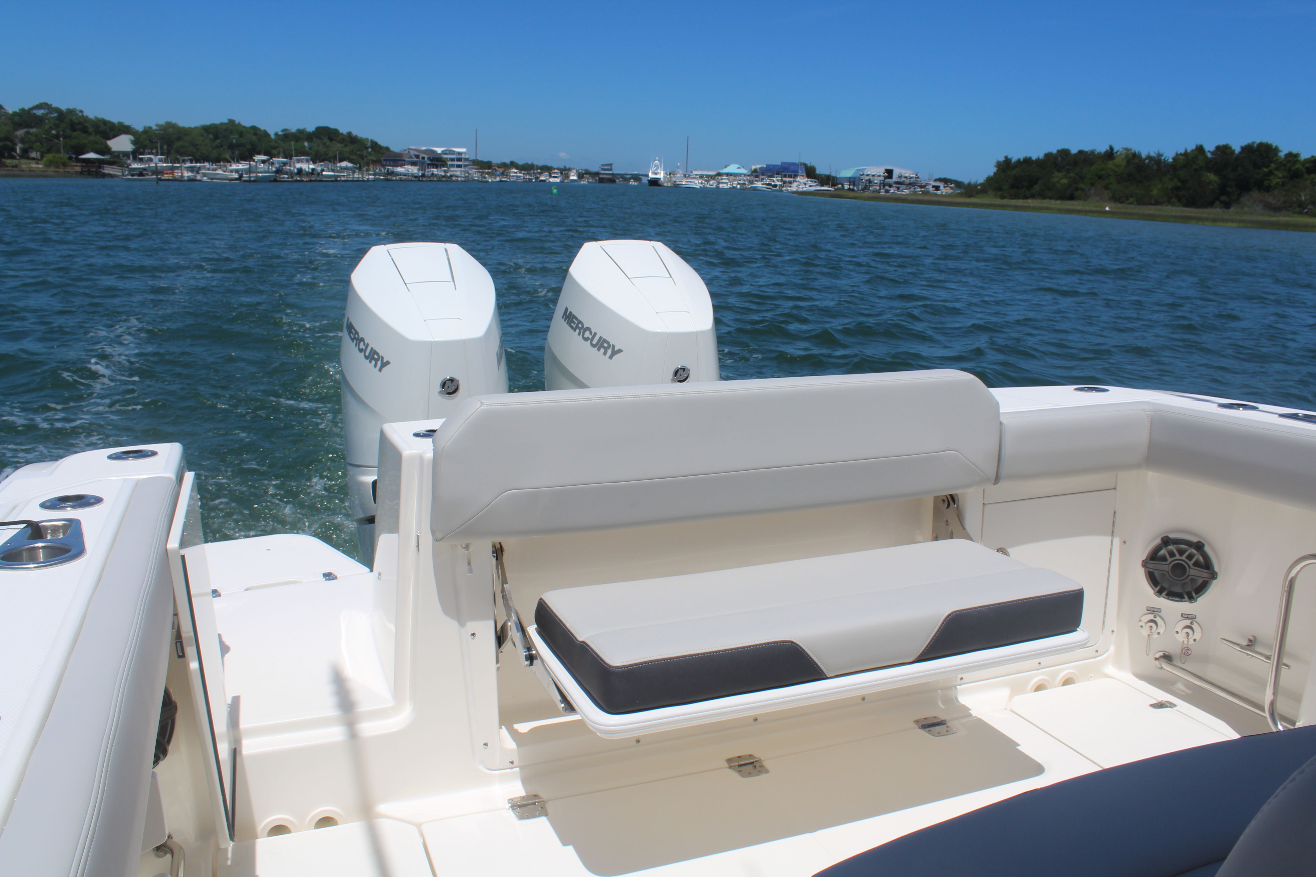 Boston Whaler 330 Outrage 2026 on water with twin Mercury engines.