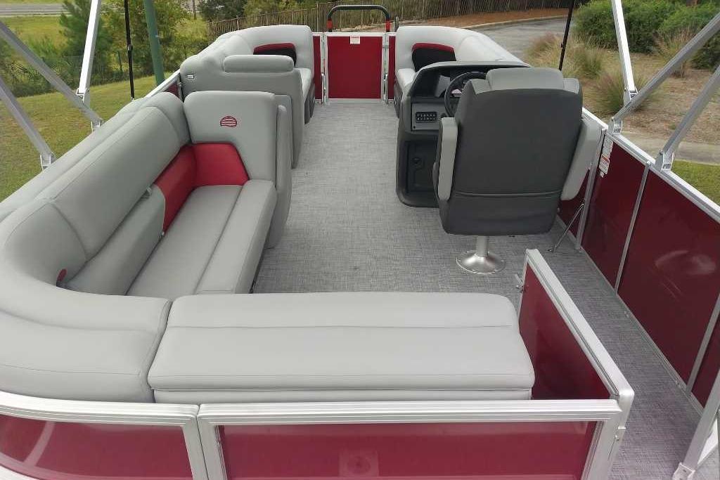 2026 Sun Tracker Party Barge 20 DLX interior with gray and red seating, steering console.