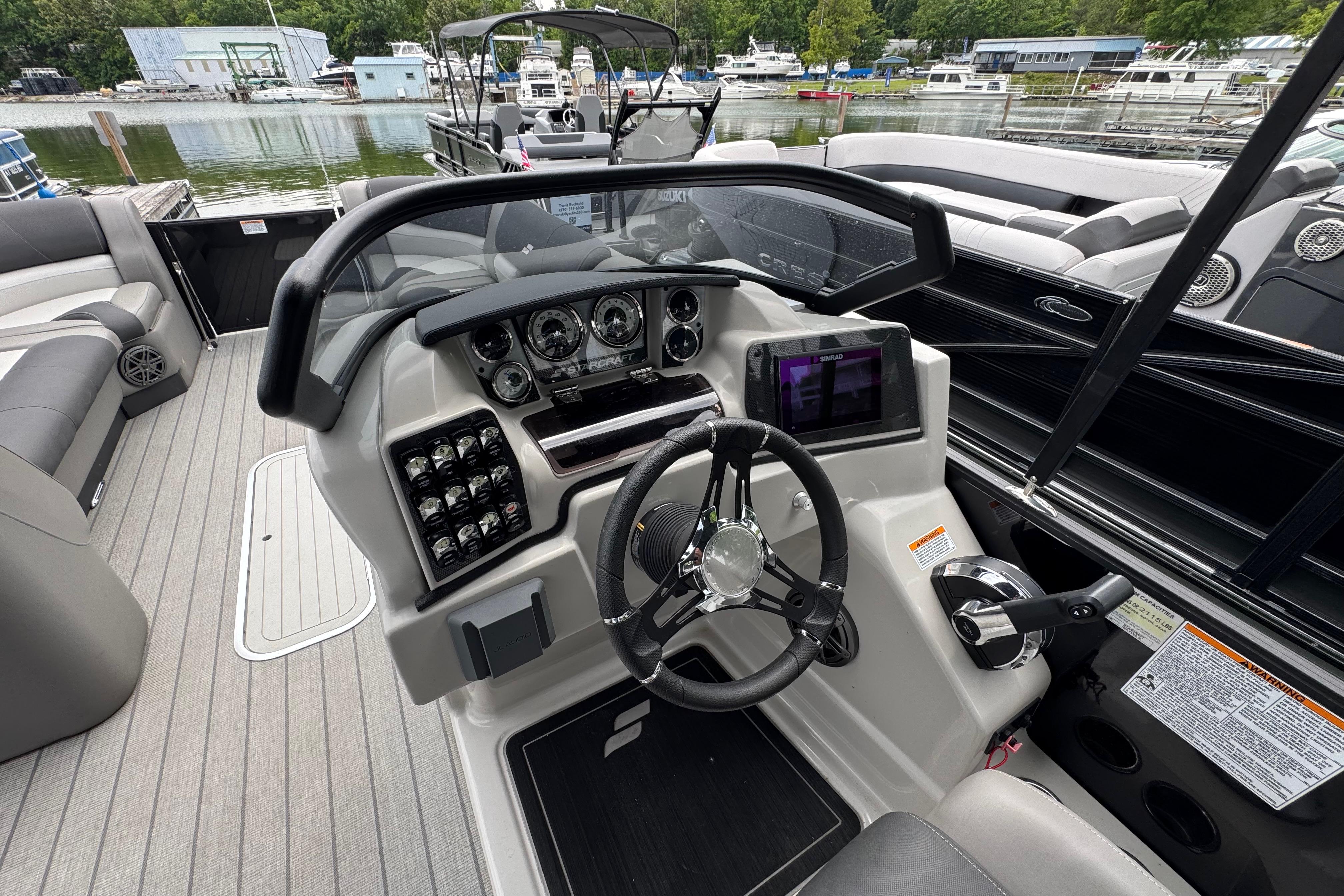 2023 Starcraft MX 25 DL DH boat dashboard with steering wheel and control panel.