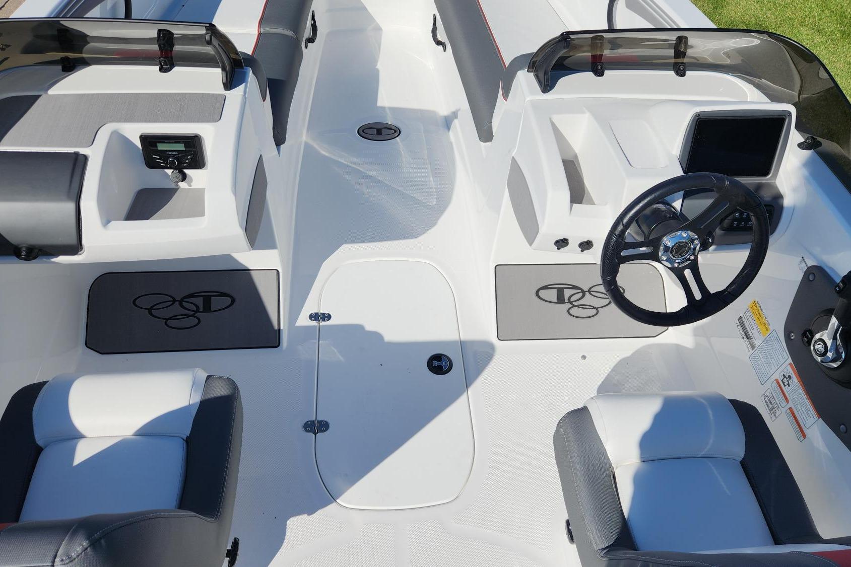 2026 Tahoe T21 boat interior with steering wheel and seating, featuring modern design elements.