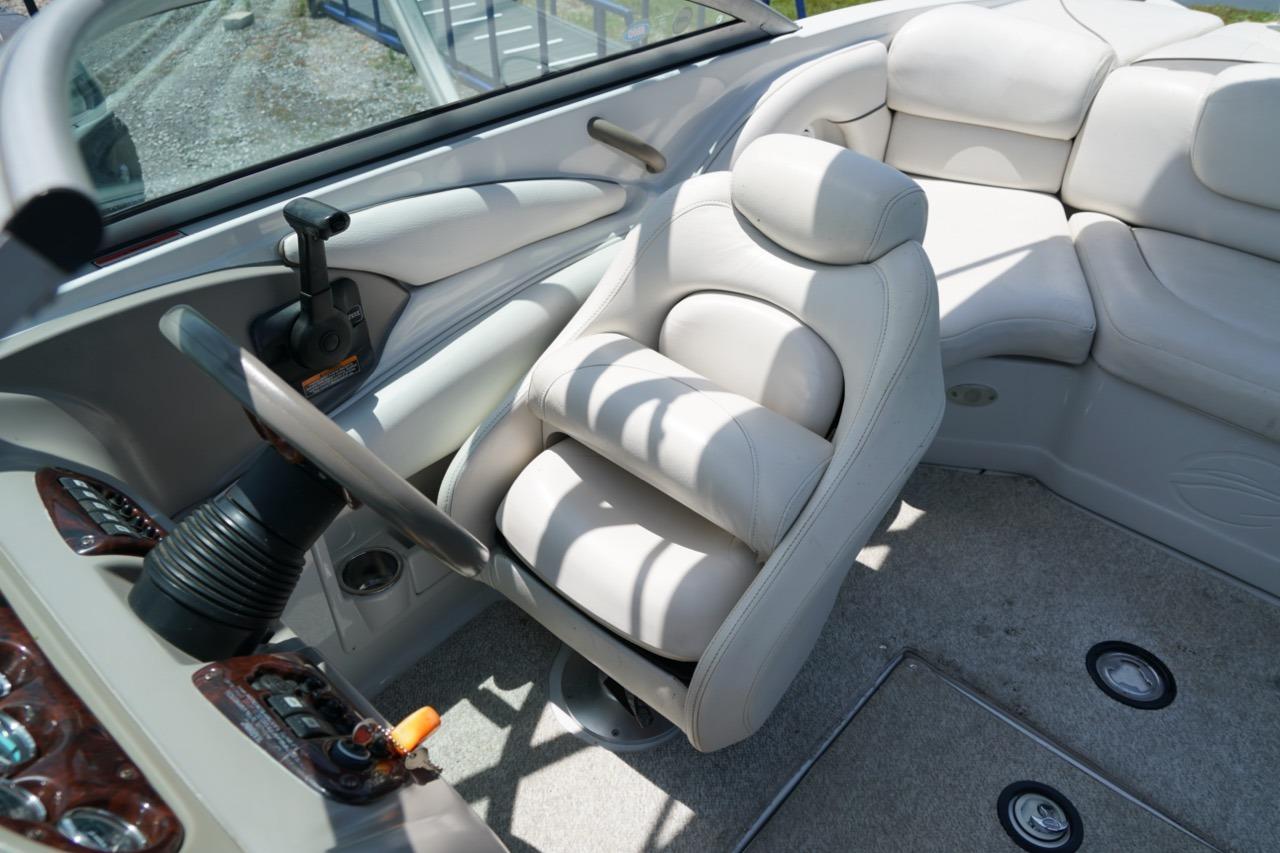 Interior of 2004 Crownline 216 LS boat with plush seating and steering wheel.