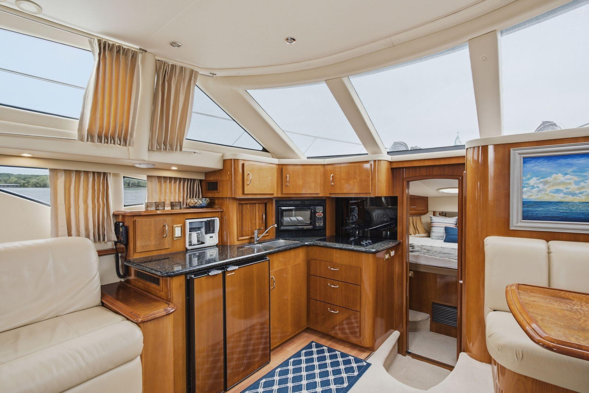 Luxurious interior of 2005 Carver 39 Motor Yacht with modern kitchen and seating area.