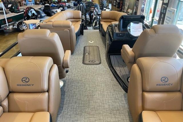 Luxurious 2026 Regency 230 DL pontoon boat interior with tan seating and modern design.