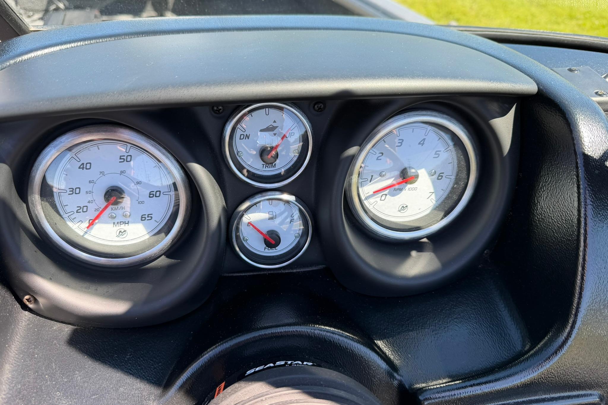 Dashboard gauges of 2024 Lund 1875 Impact XS Sport boat, showing speed, trim, and fuel levels.