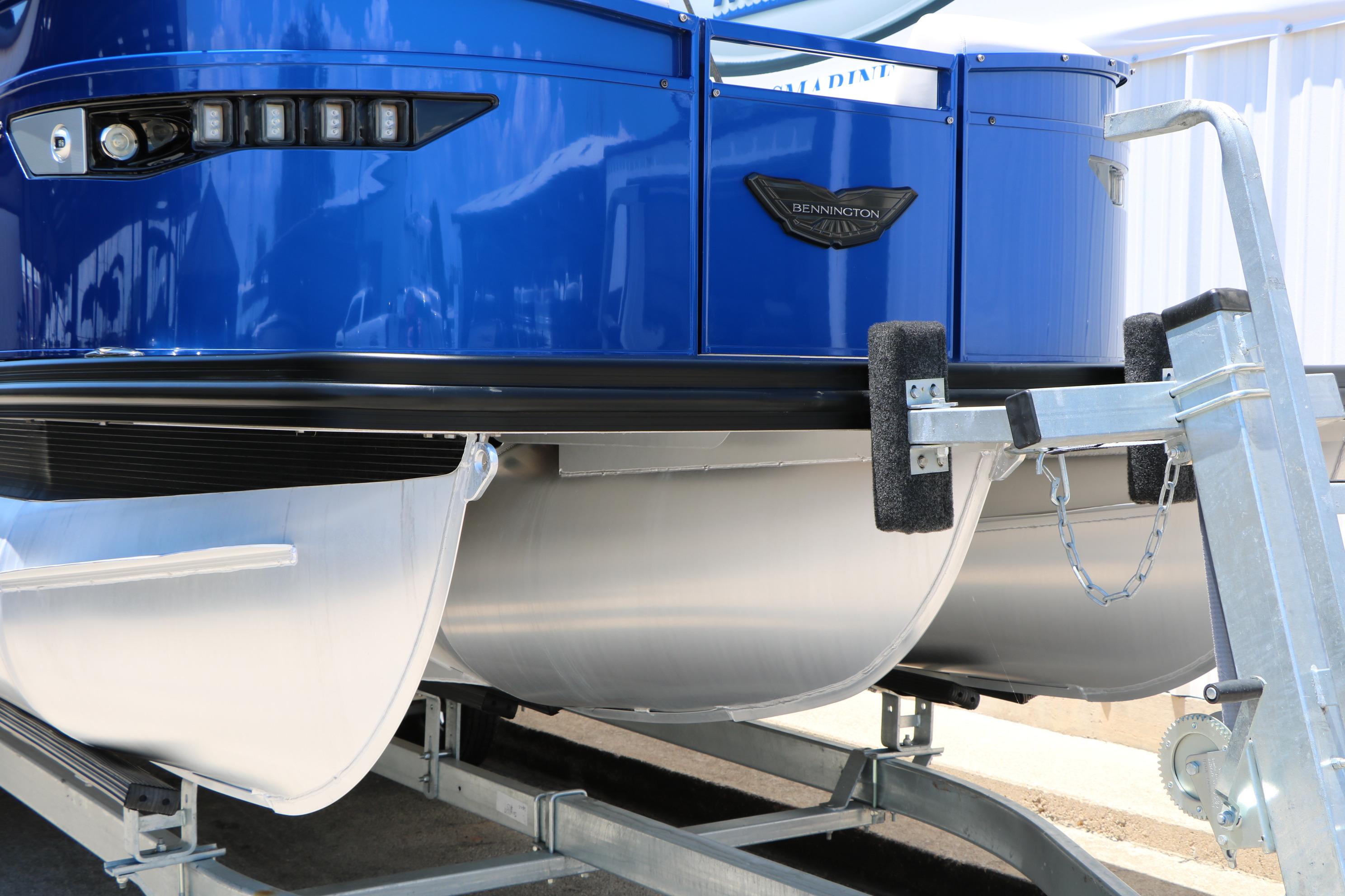 2024 Bennington 23 RX Swingback pontoon boat on trailer, featuring sleek blue design.