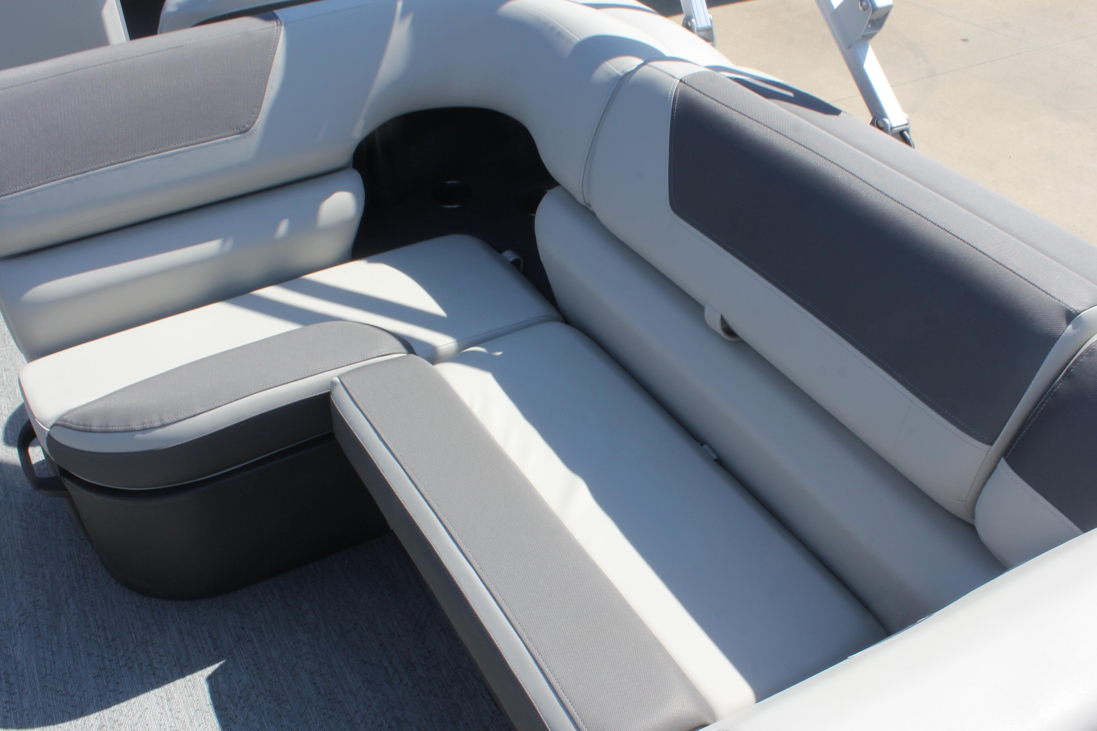 2026 Sun Tracker Fishin' Barge 20 DLX boat seating, featuring gray and white upholstery.