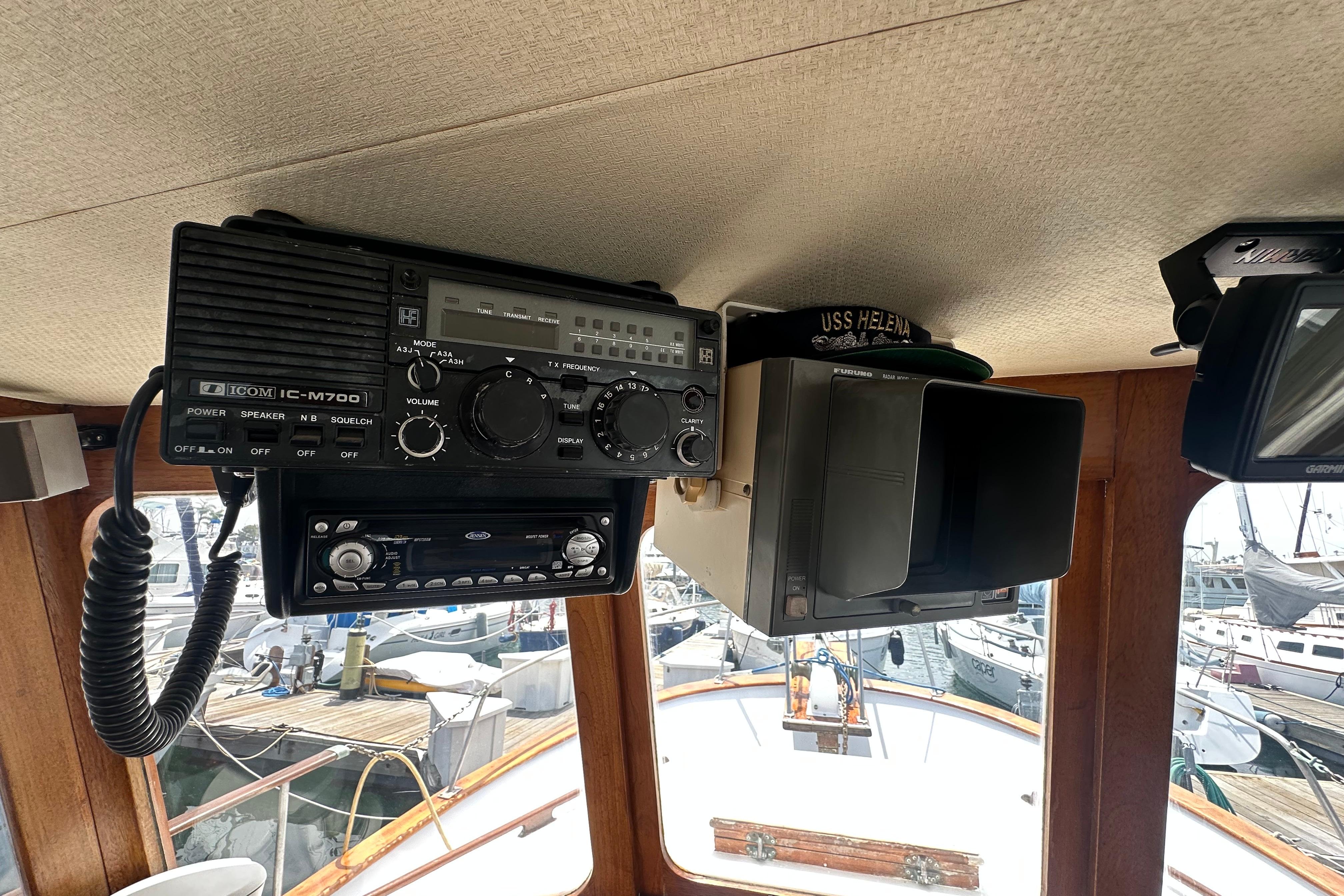 Boat interior with Icom IC-M700 radio, Furuno radar, and marina view, CHB 33, 1973 model.
