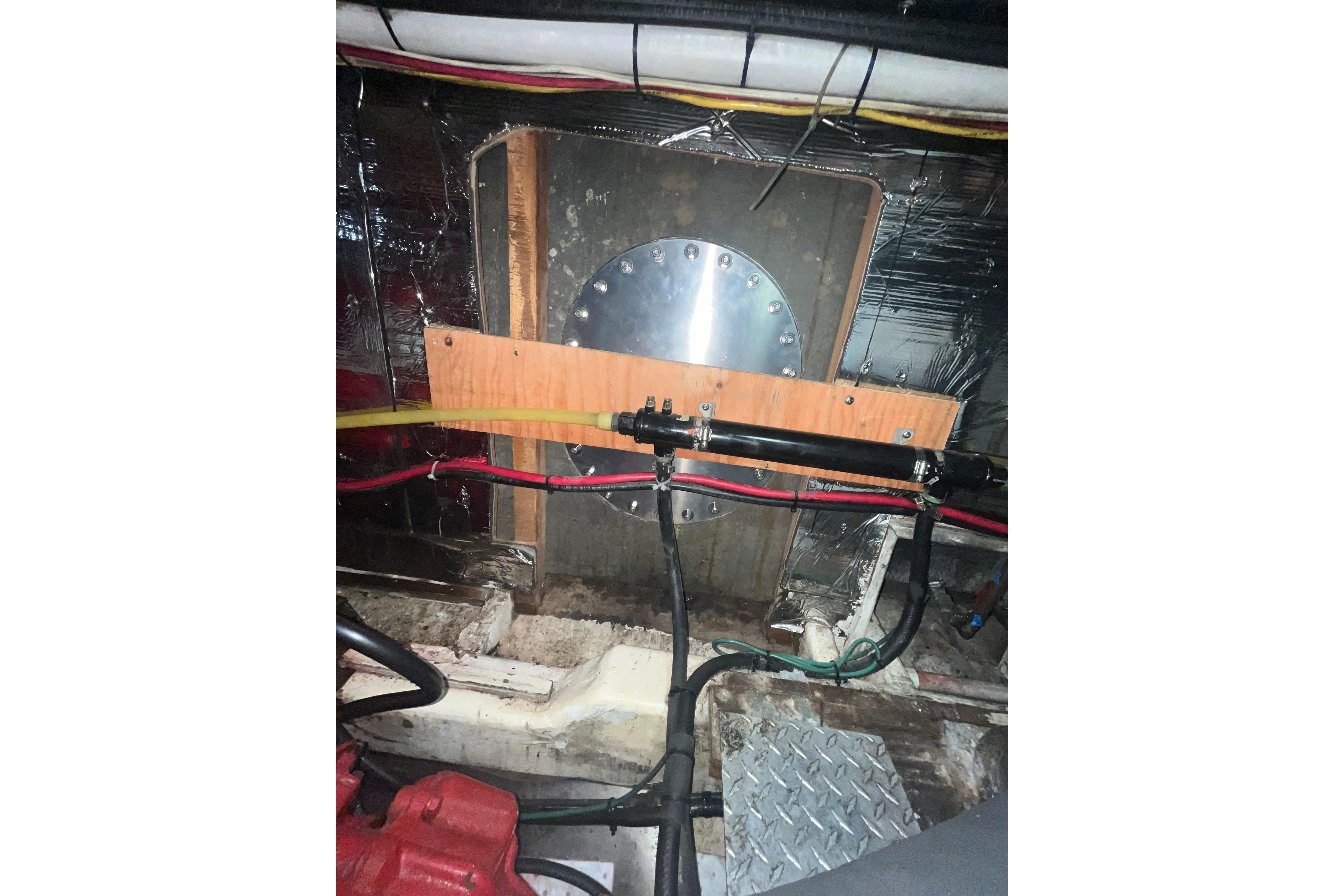 Engine room of 1986 Sea Ranger 47 Pilothouse with wiring and metal components.