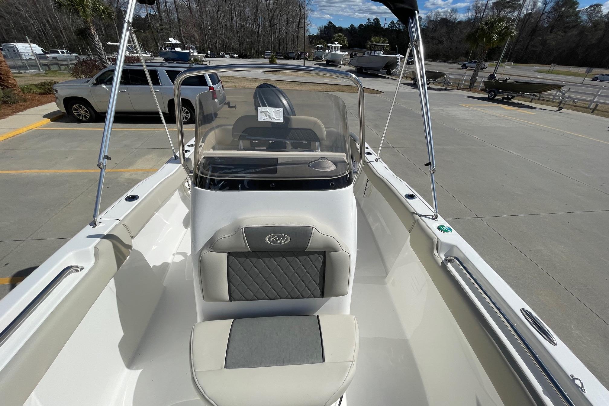2026 Key West 203 FS boat with sleek seating and console, parked outdoors.