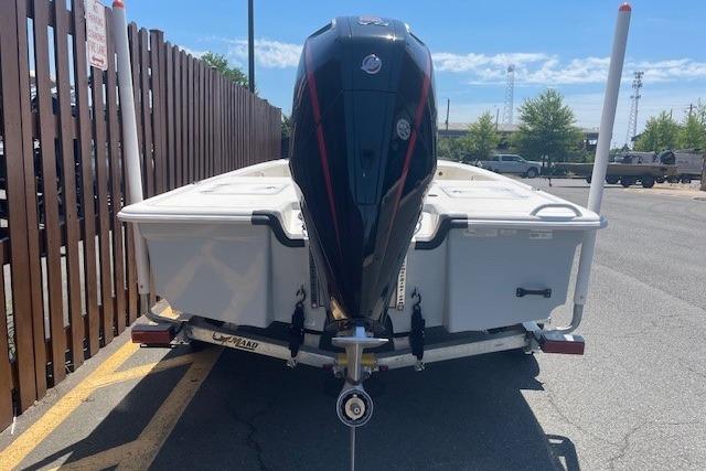 2026 Mako 18 Pro Skiff boat with outboard motor, parked on a trailer.