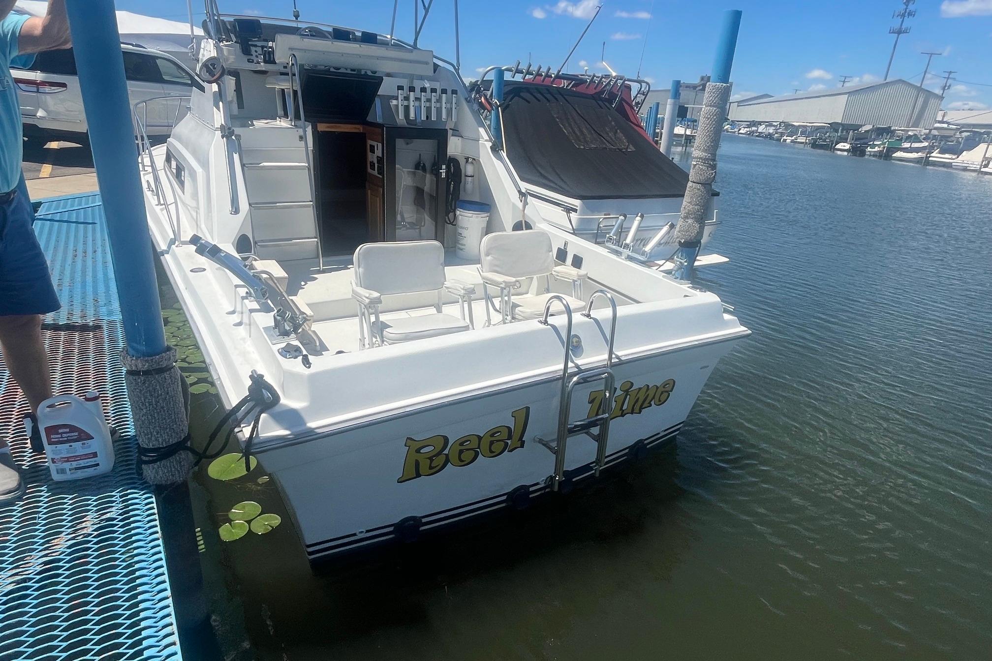 1988 Seafox 29 Flybridge boat named "Reel Time" docked at a marina.