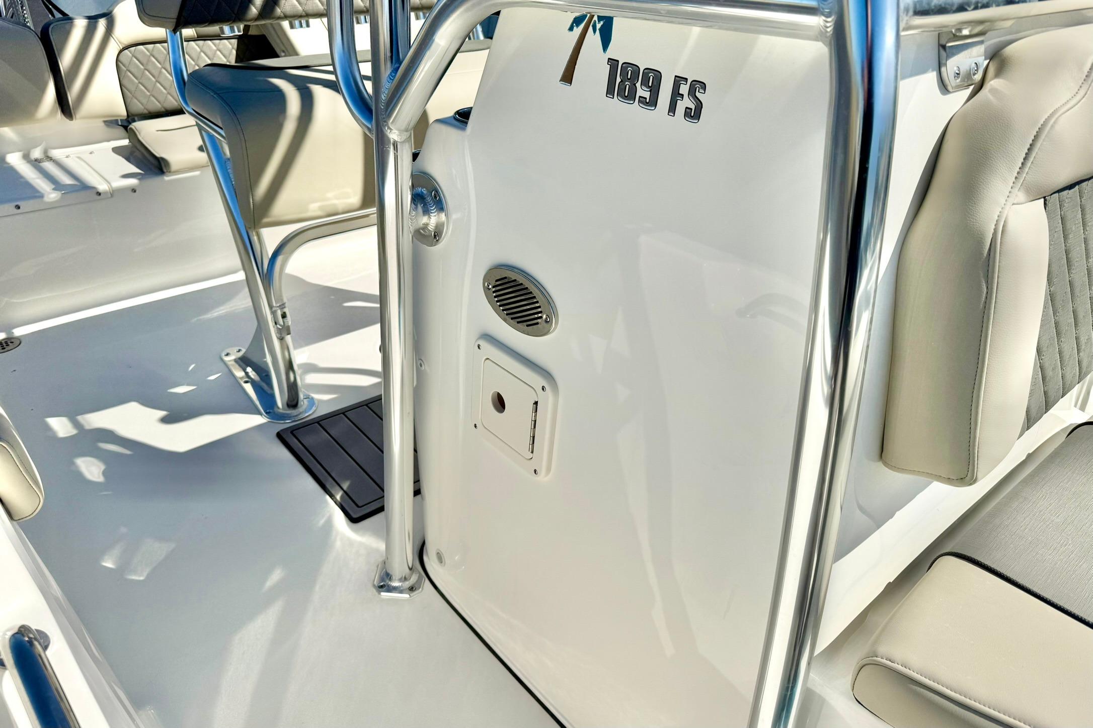 2026 Key West 189 FS boat interior with seating and stainless steel details.