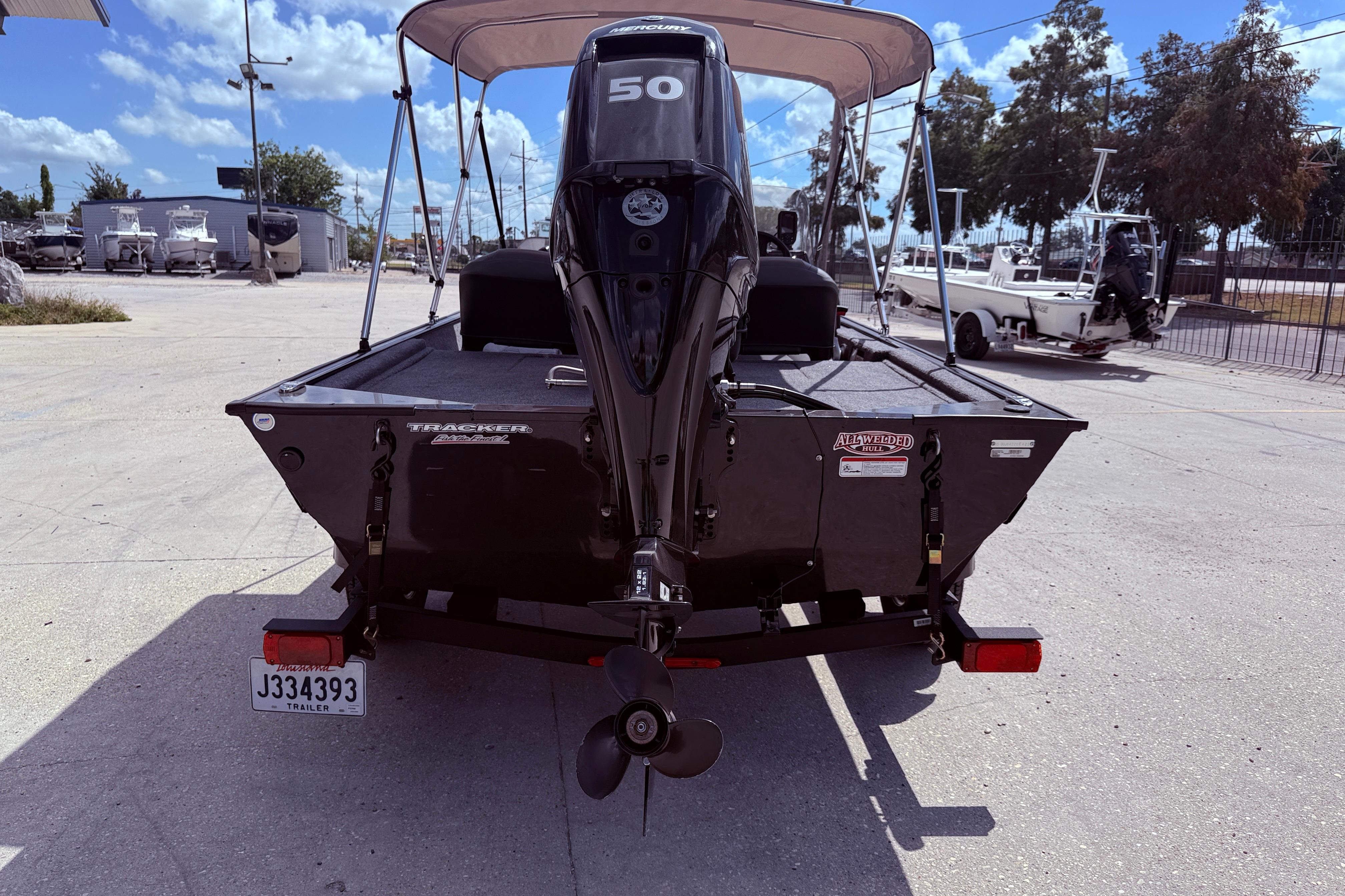 2025 Bass Tracker Classic XL boat with outboard motor, parked on a trailer.