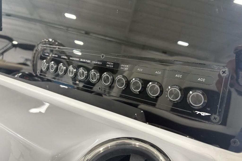 Control panel of 2026 Tidewater 2210 Carolina Bay boat with labeled switches.