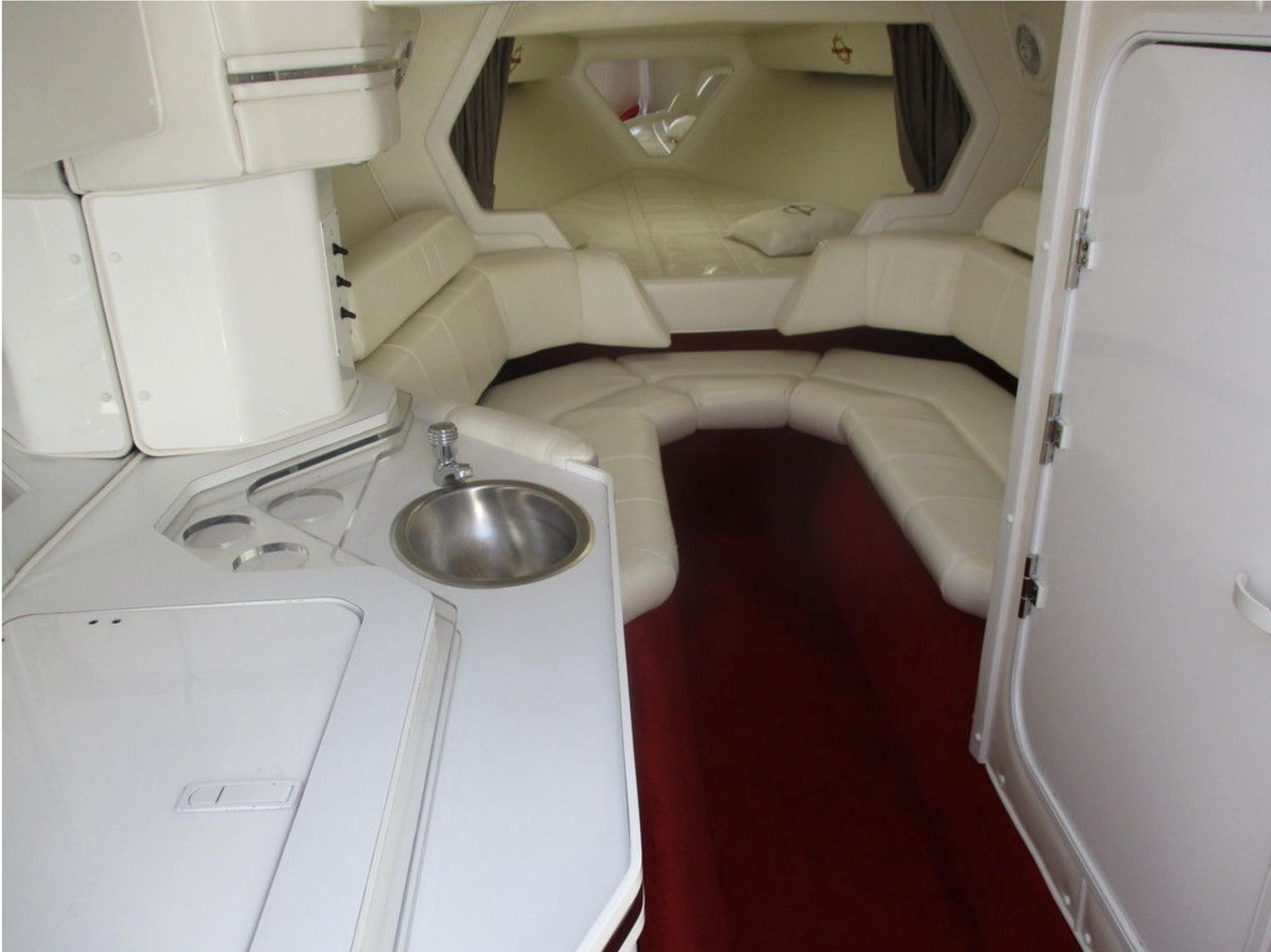 2003 Fountain 38 Lightning boat interior with white leather seating and kitchenette.