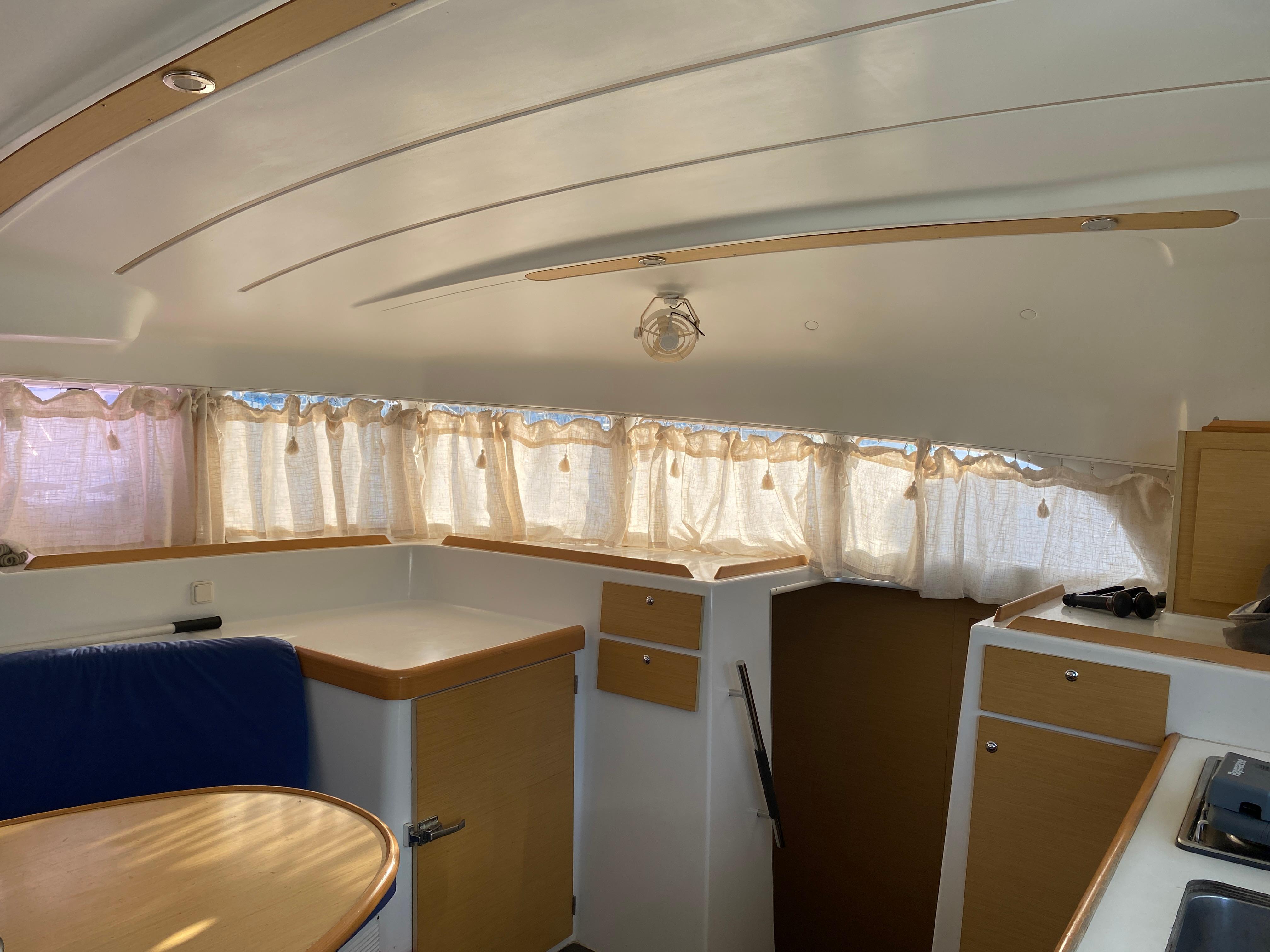 Interior of 2013 Lagoon 380 catamaran with cozy seating and natural light.