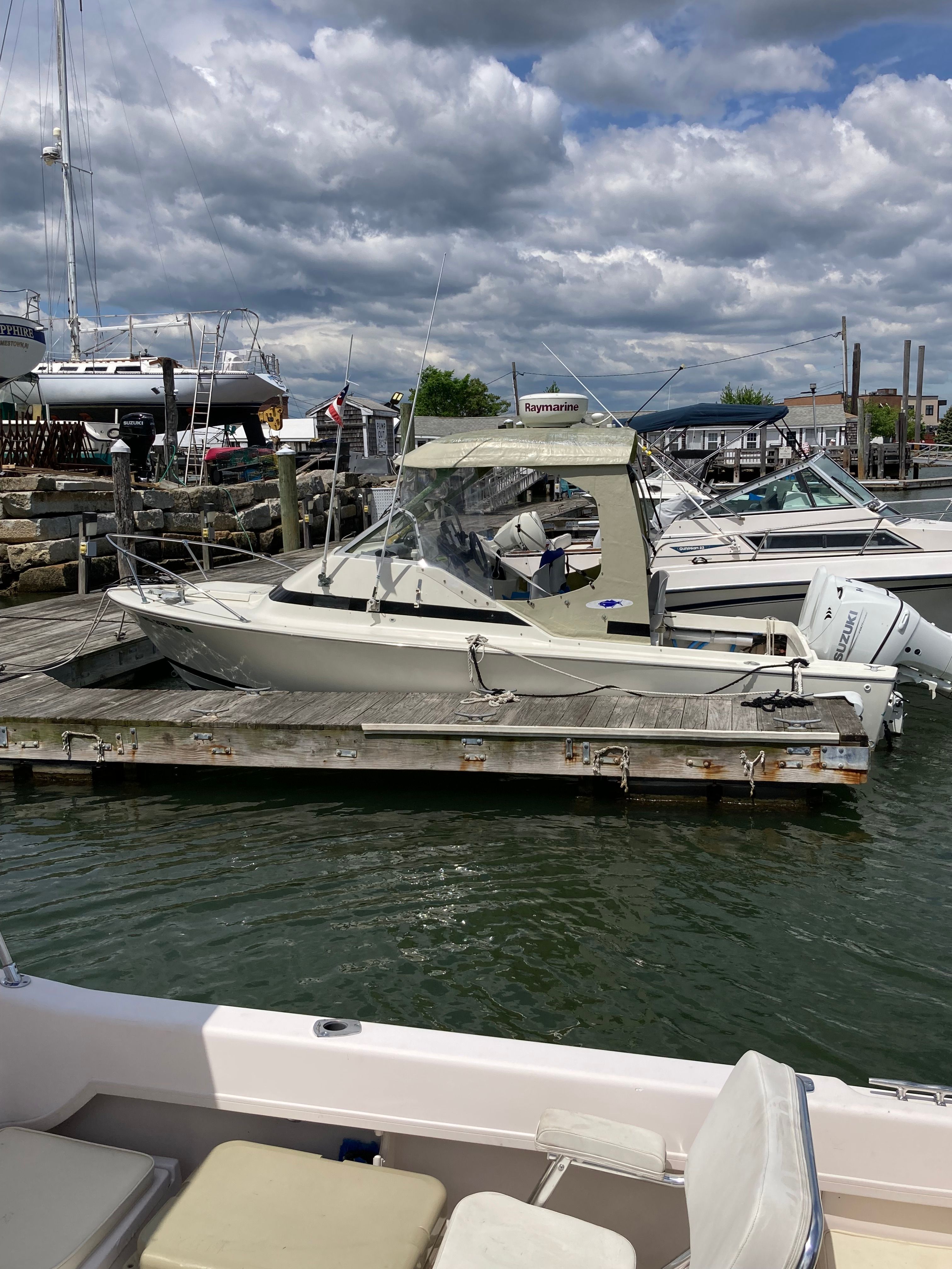 A 1969 Bertram Bahia Mar is docked. The sky is cloudy.