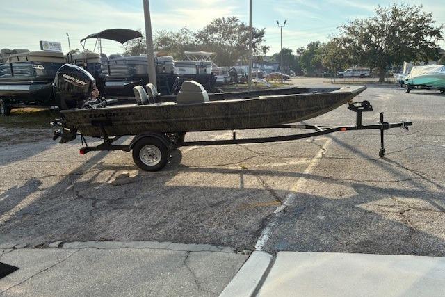 2026 Tracker Grizzly 1754 SC boat on trailer in parking lot, side view.