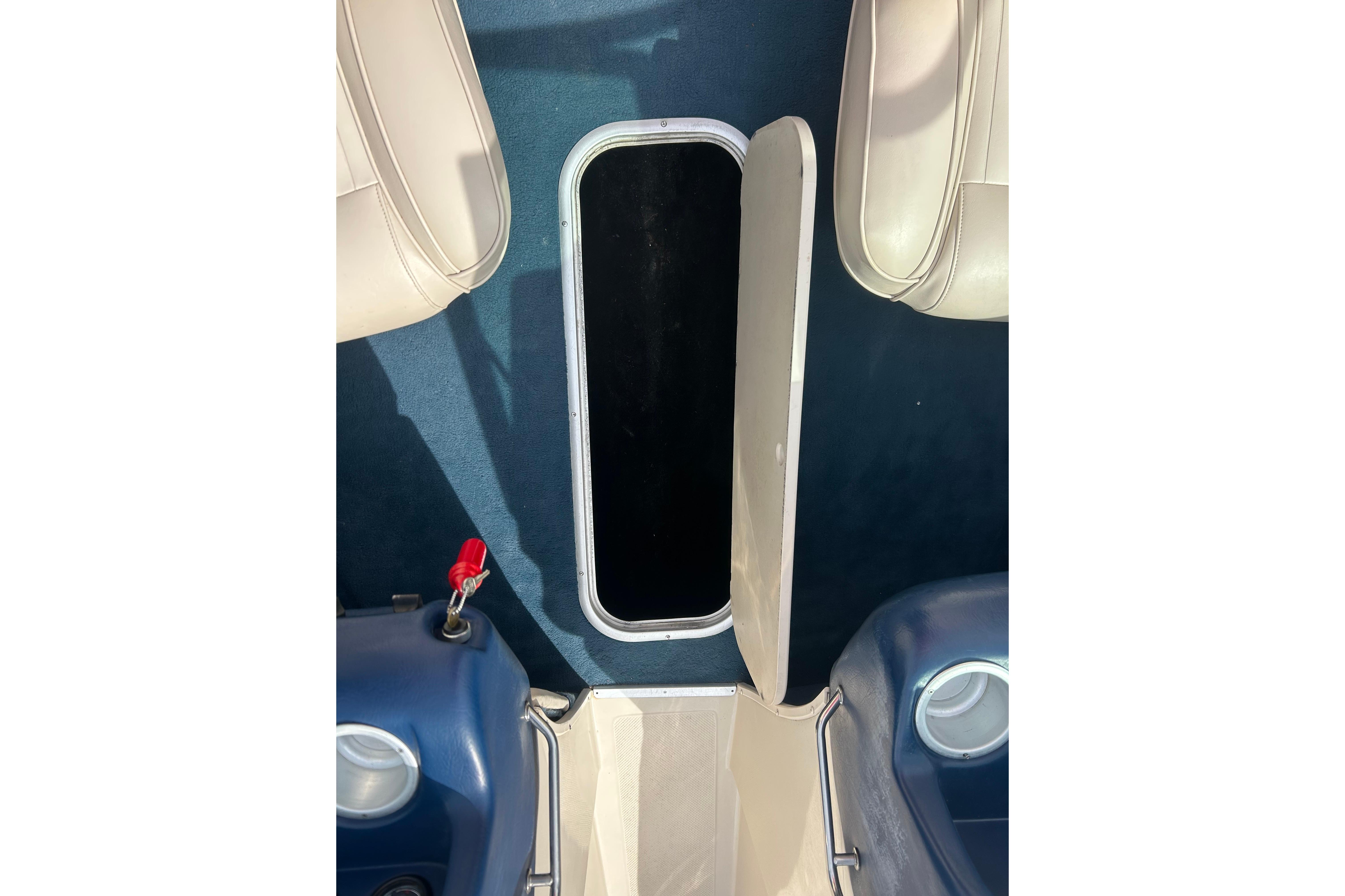 Open storage compartment on 1996 Mariah 180 Shabah boat interior.
