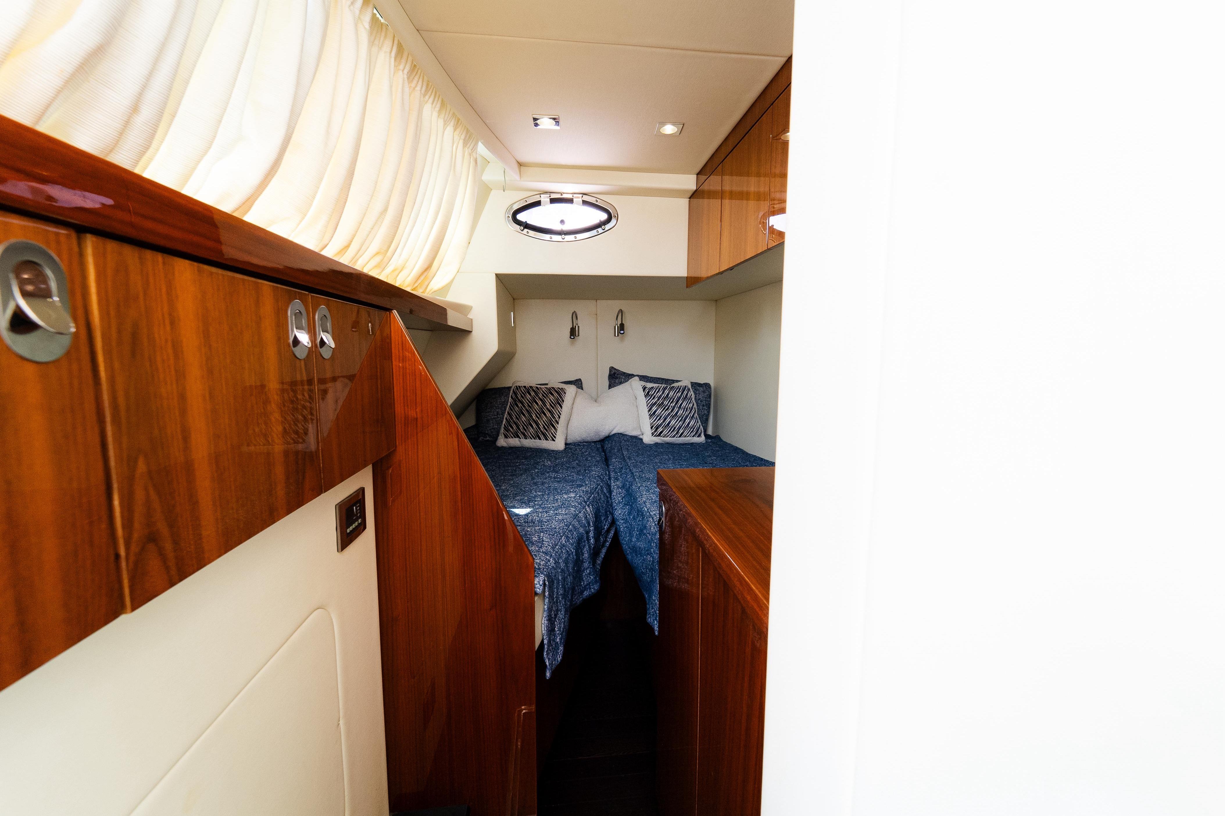 Luxurious cabin interior of 2016 Sunseeker Manhattan 65 yacht with elegant wood finish.