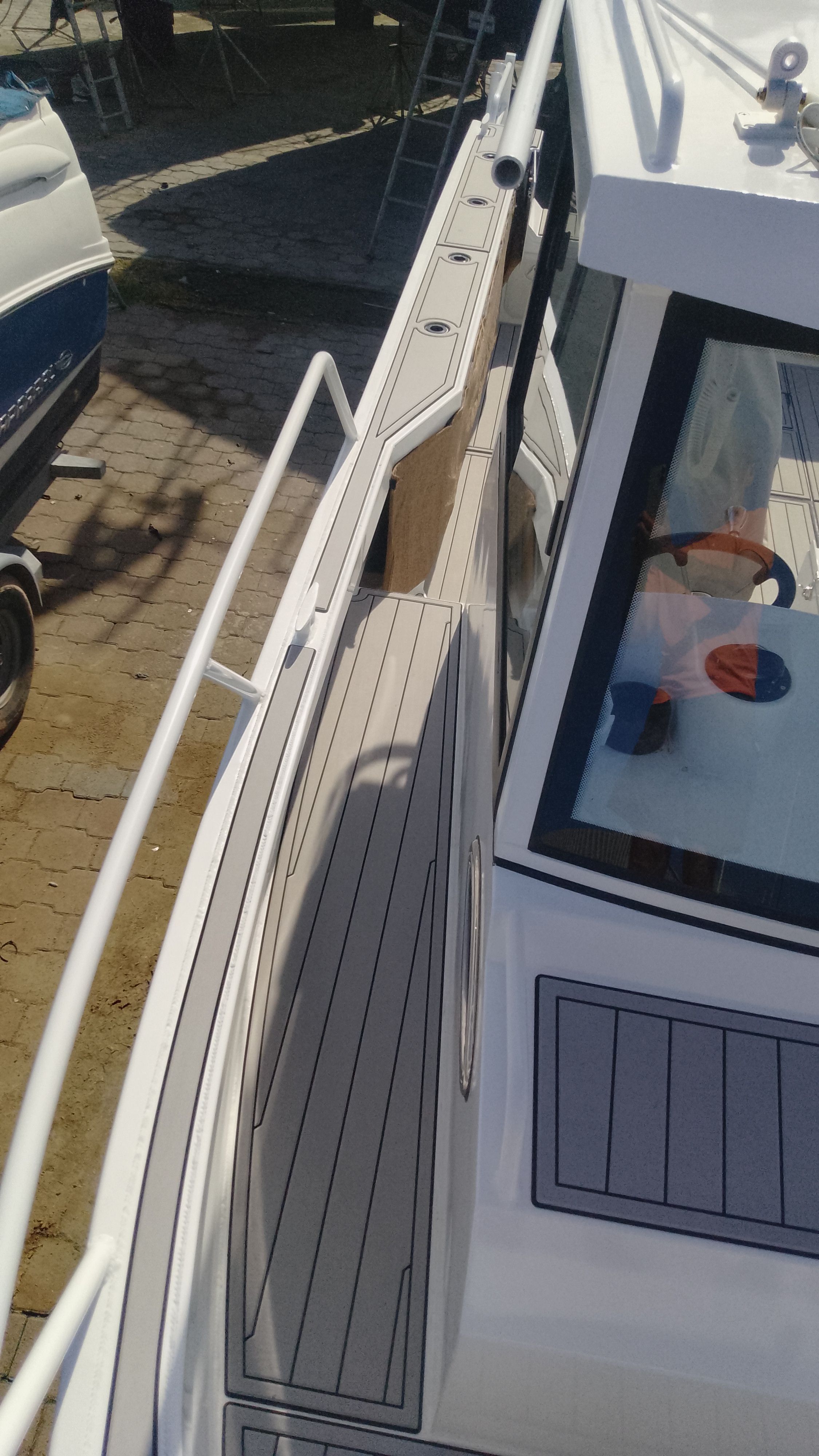 Gospel Boat 7.5M 2024, side view of deck and railing.