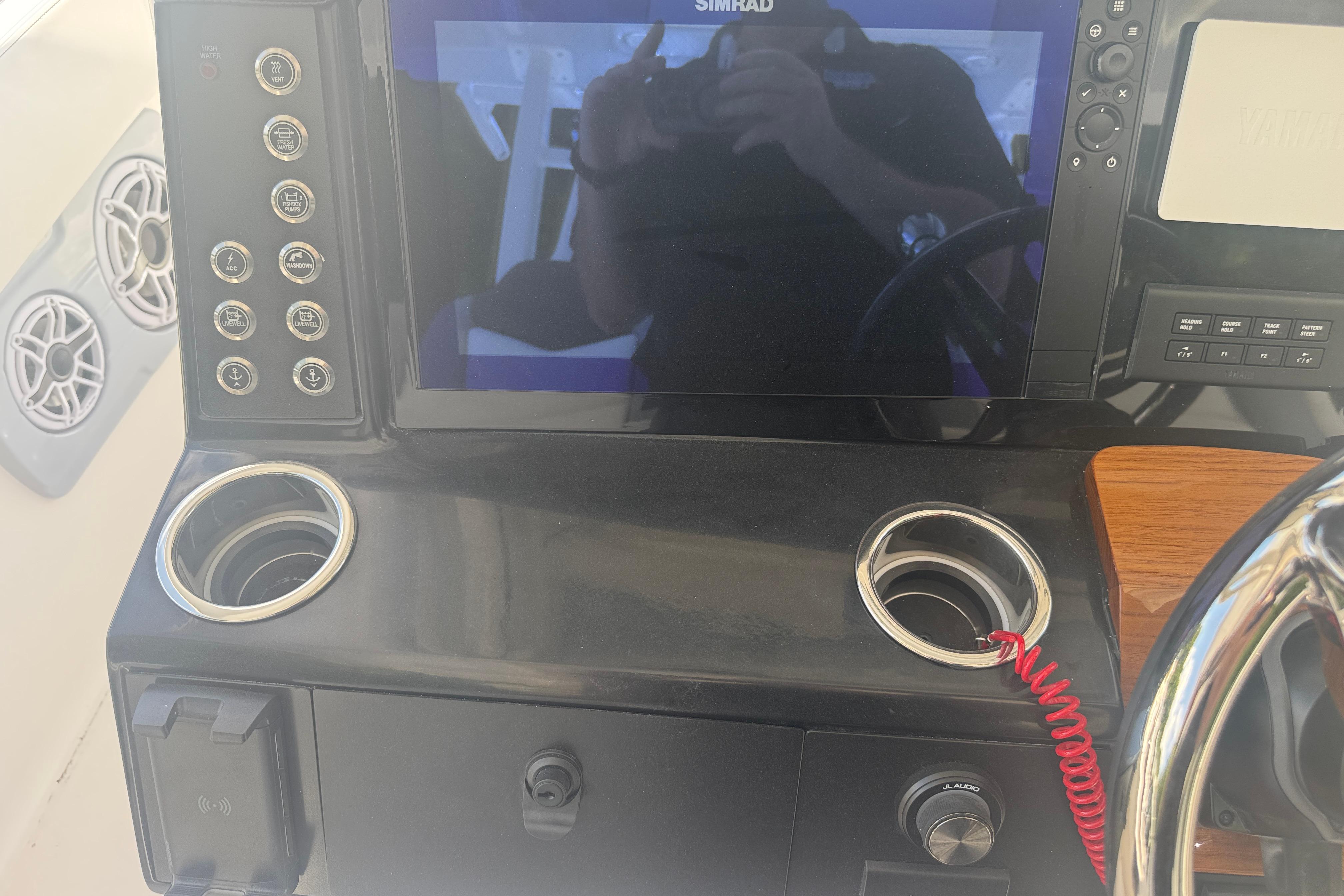 Control panel of 2025 Robalo R300 Center Console boat with steering wheel and electronics.