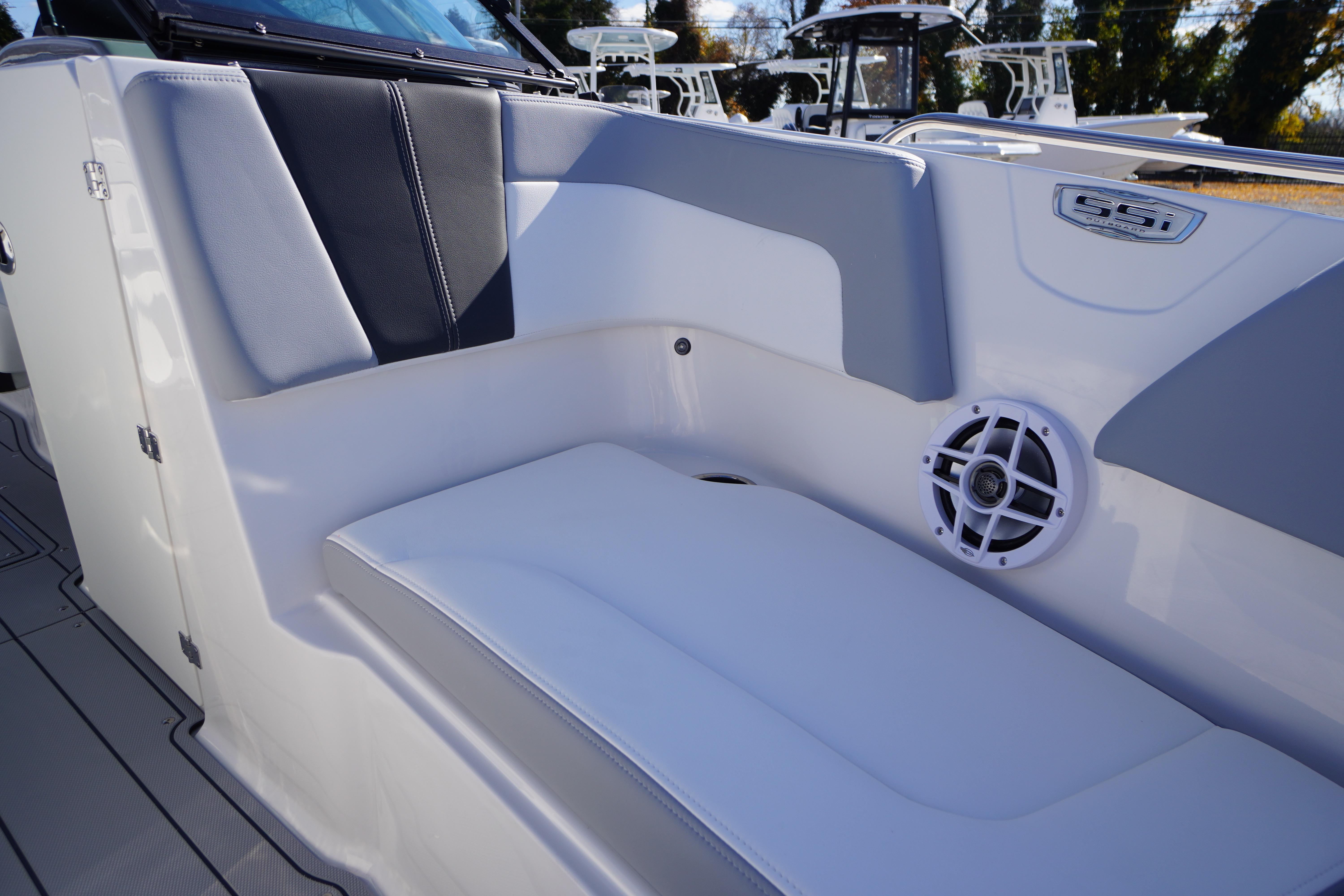 2026 Chaparral 23 SSi OB boat interior with cushioned seating and speaker.