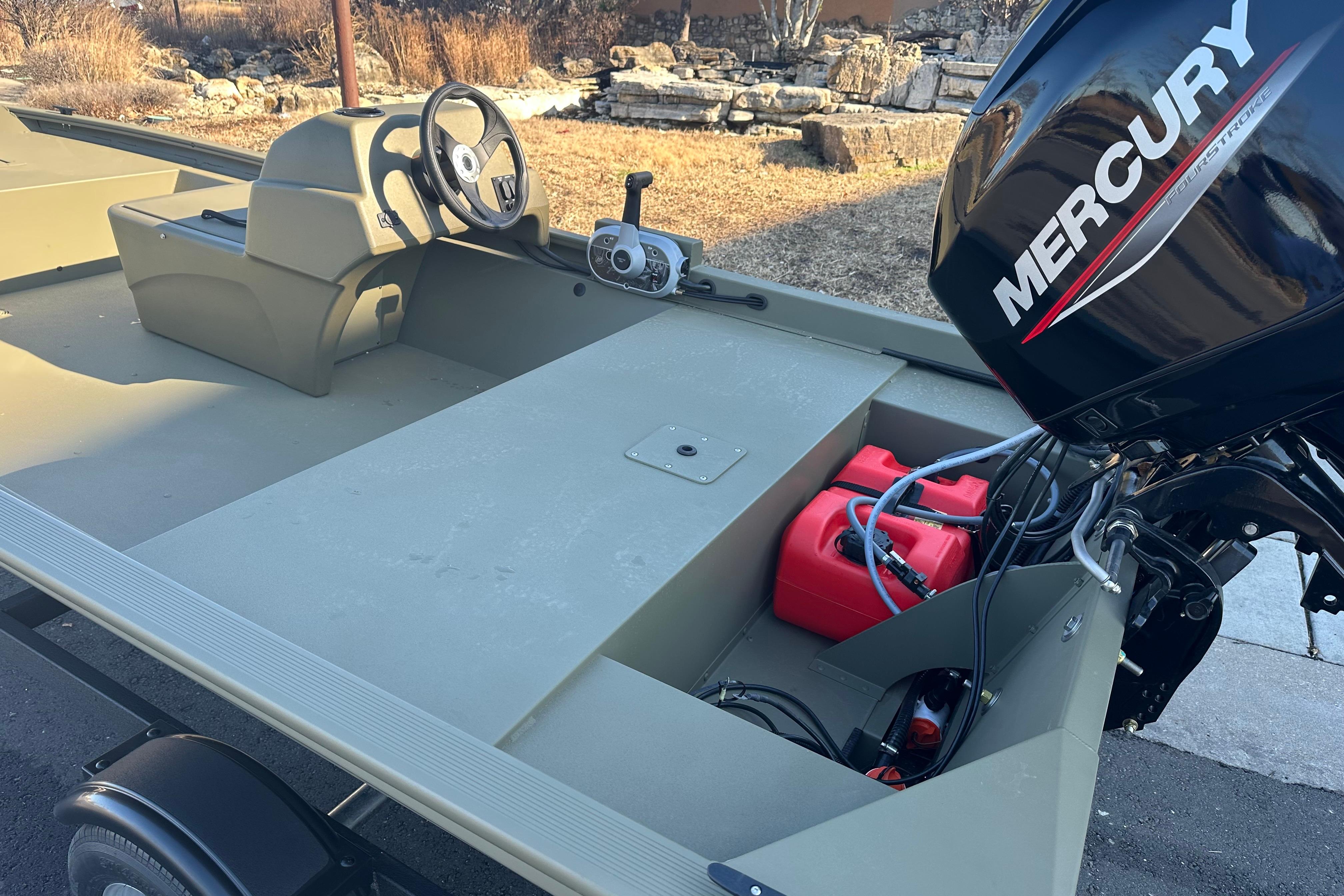 2026 Tracker Grizzly 1648 SC boat with Mercury outboard motor, steering console, and fuel tank.