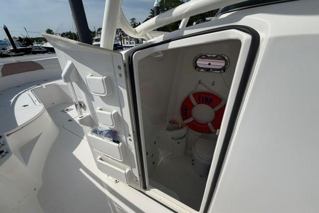 2014 Edgewater 318CC boat interior with open storage compartment and life preserver.