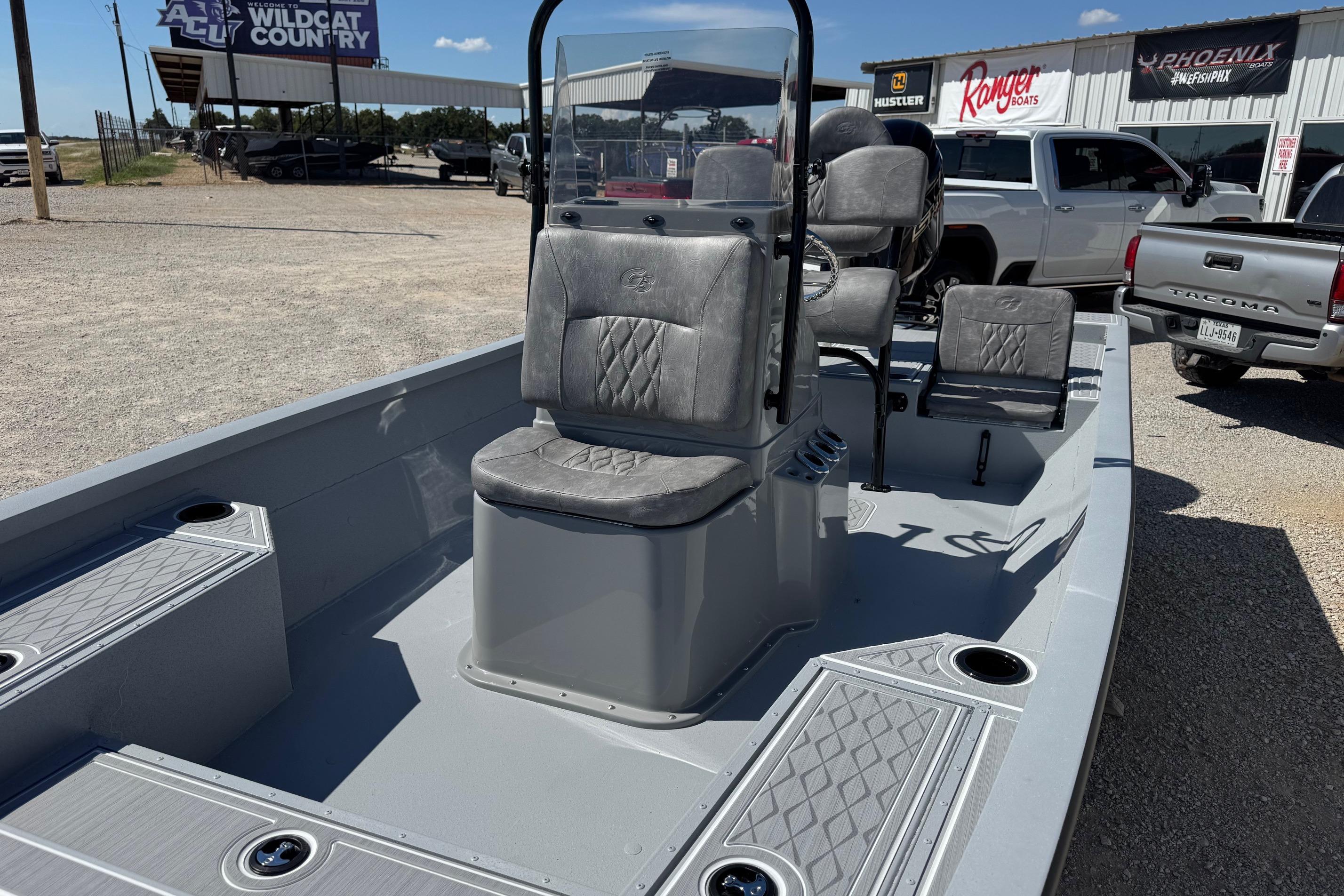 2026 G3 21GX boat with gray seating and console, parked outdoors.