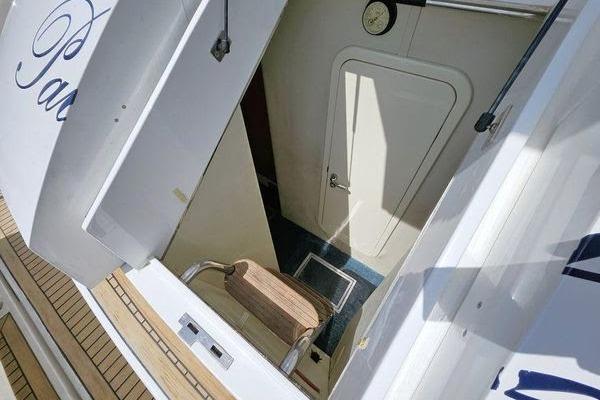 Sunseeker Manhattan 66 yacht interior entrance, featuring a wooden step and white door, 2005 model.