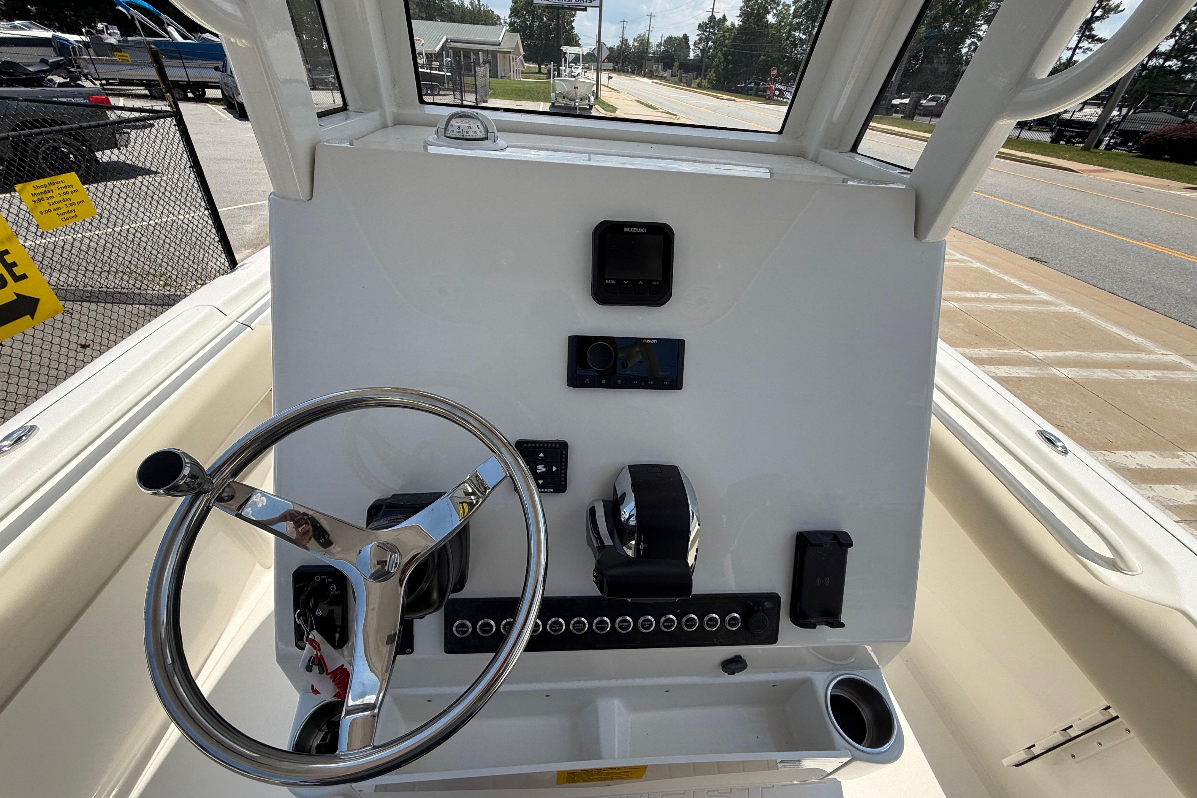2027 Key West 249 FS boat dashboard with steering wheel and controls.