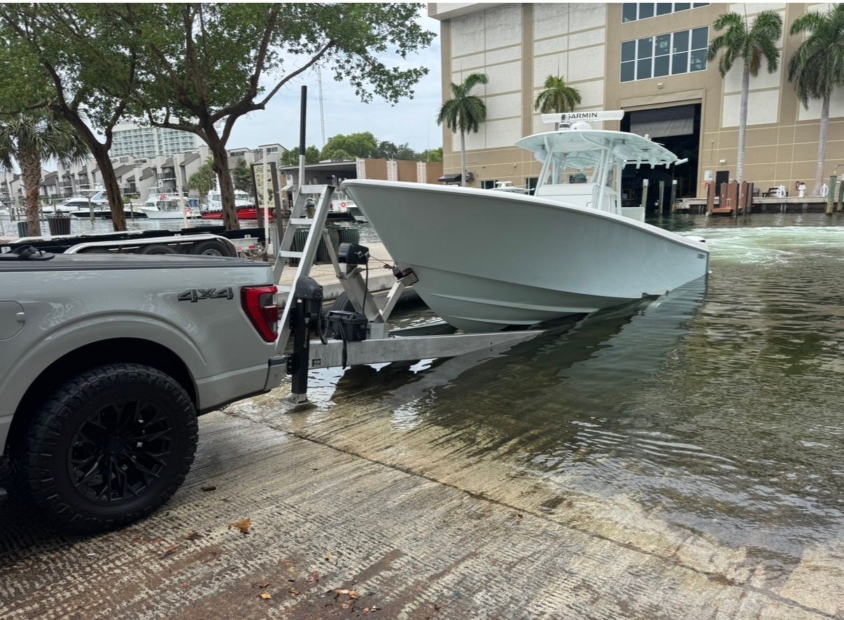 2019 Contender 35 ST boat on trailer at waterfront.