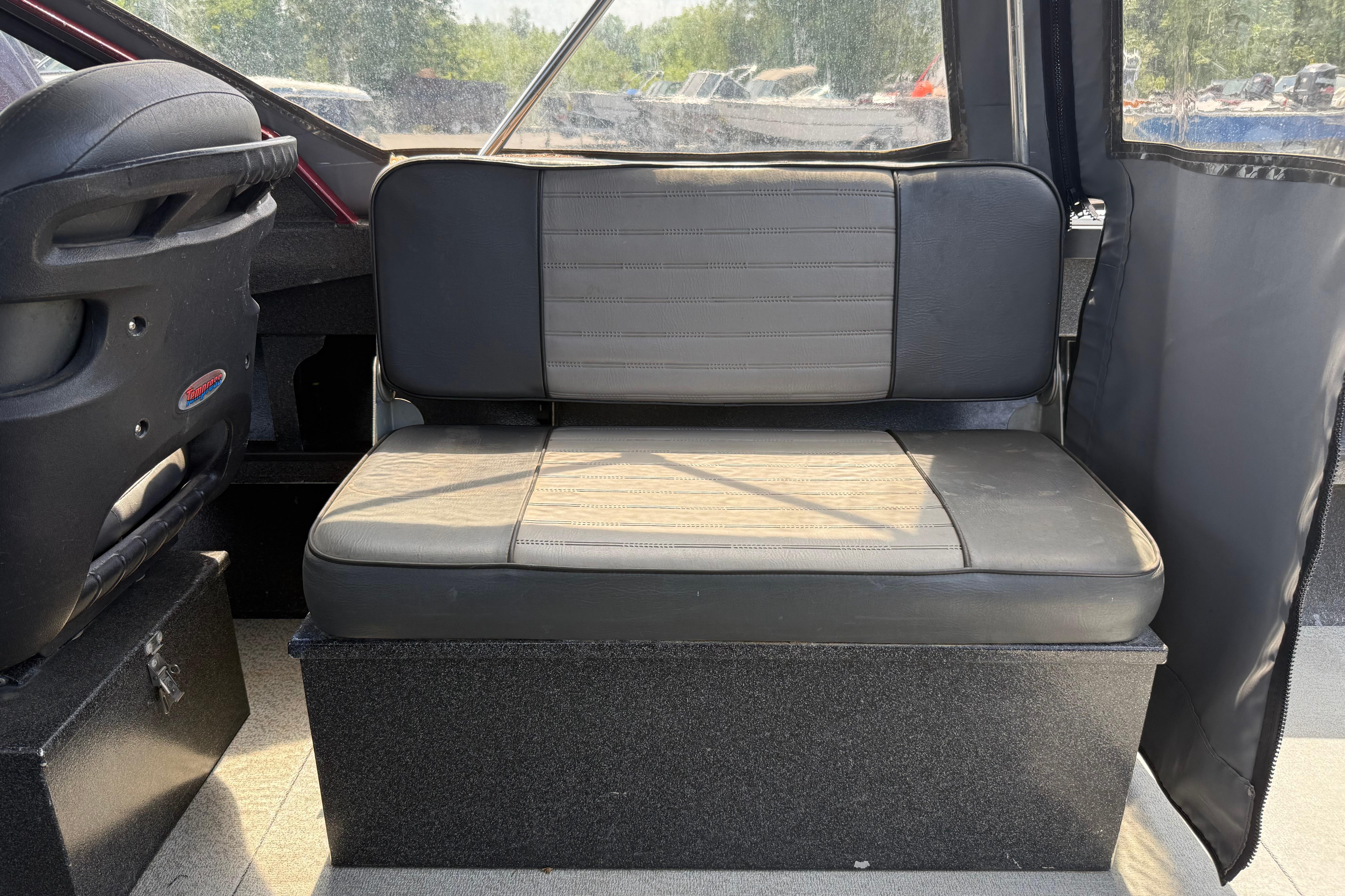 Interior seating of a 2005 Willie Raptor 21' boat, featuring black and gray upholstery.
